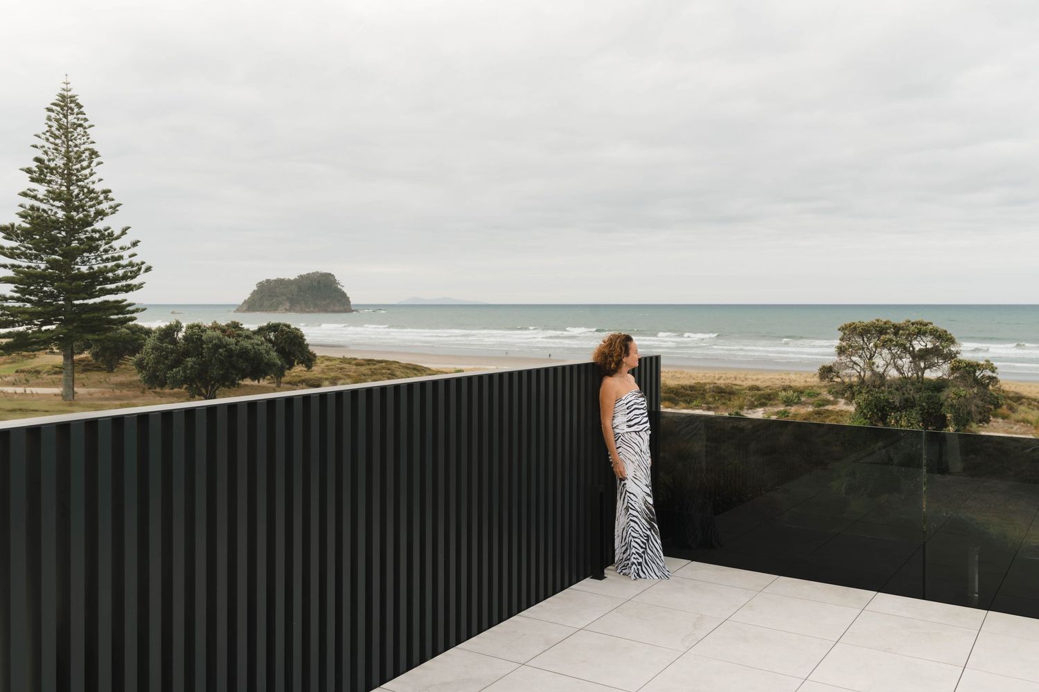 Oceanfront terrace with black privacy screens overlooking scenic coastal views.