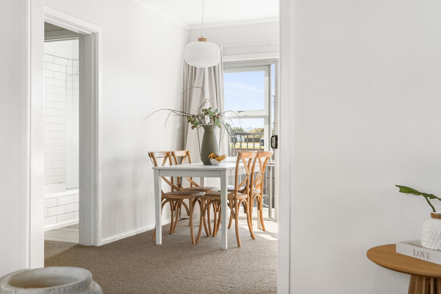 Bright white hallway with natural light showcasing minimalist interior design.