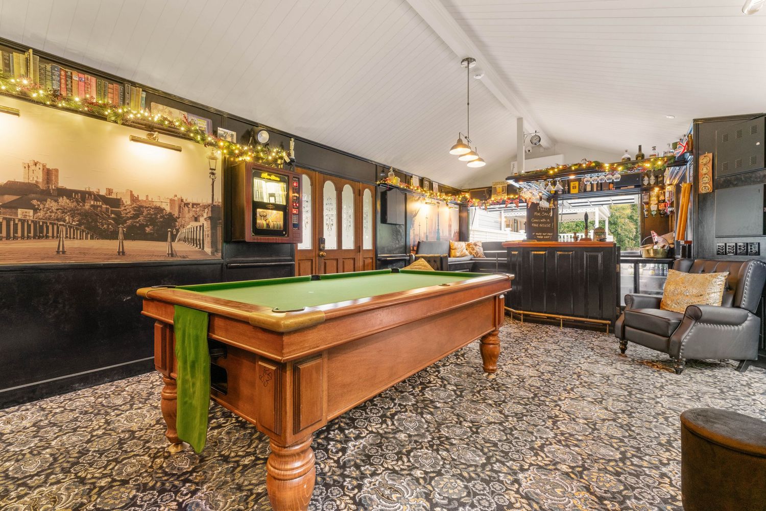 Game room interior with pool table and ambient lighting in modern finished space.