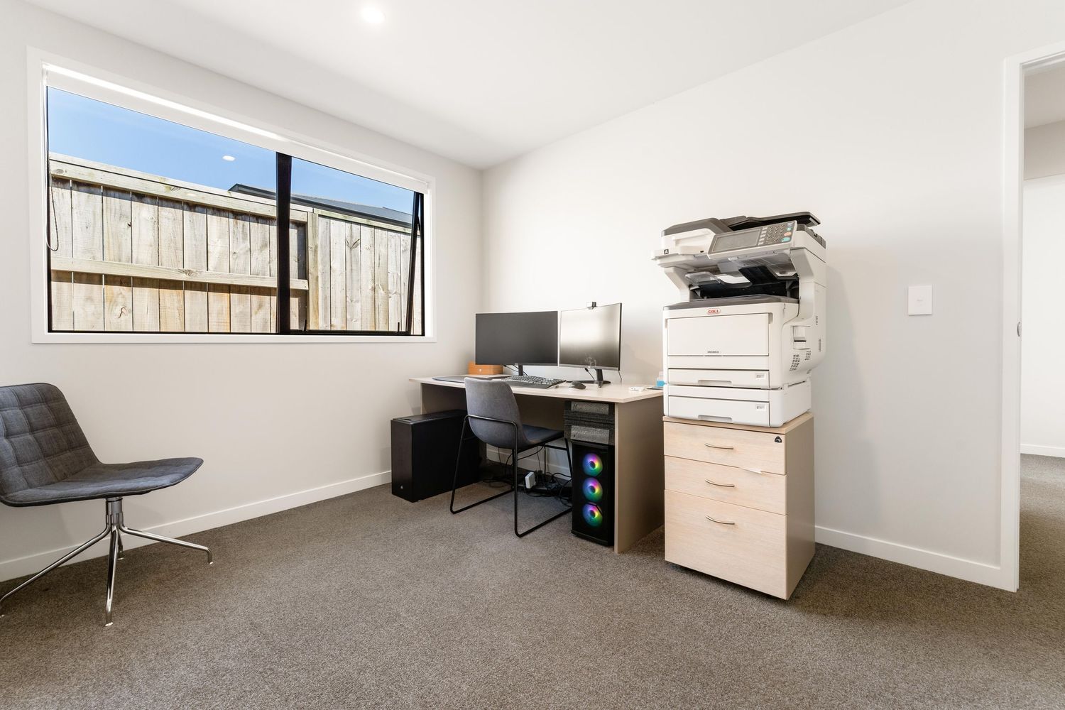 Minimalist bedroom interior with views through highlight windows and built-in storage solutions.