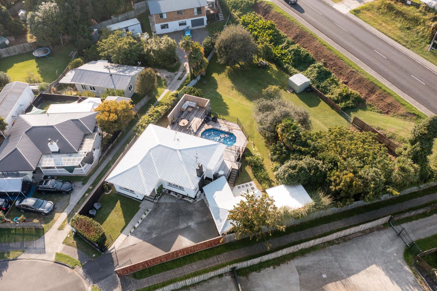 Aerial view of suburban homes and properties with well-maintained yards and driveways.