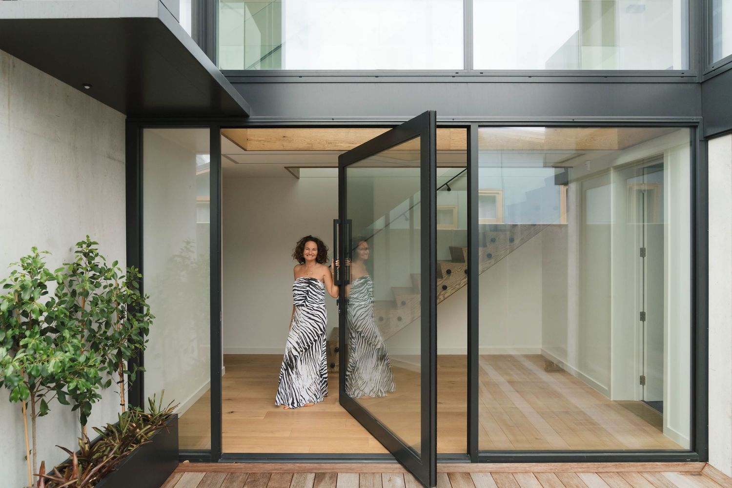 Modern home interior with glass walls and minimalist architectural design.