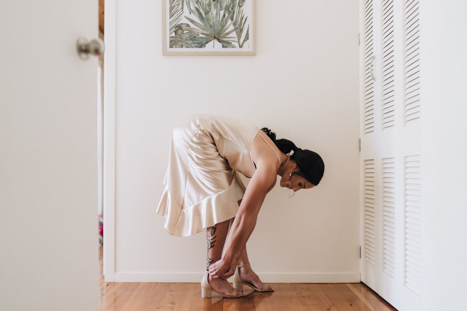 A series of graceful dancing poses captured in a bright white room with curtains and hardwood floors.