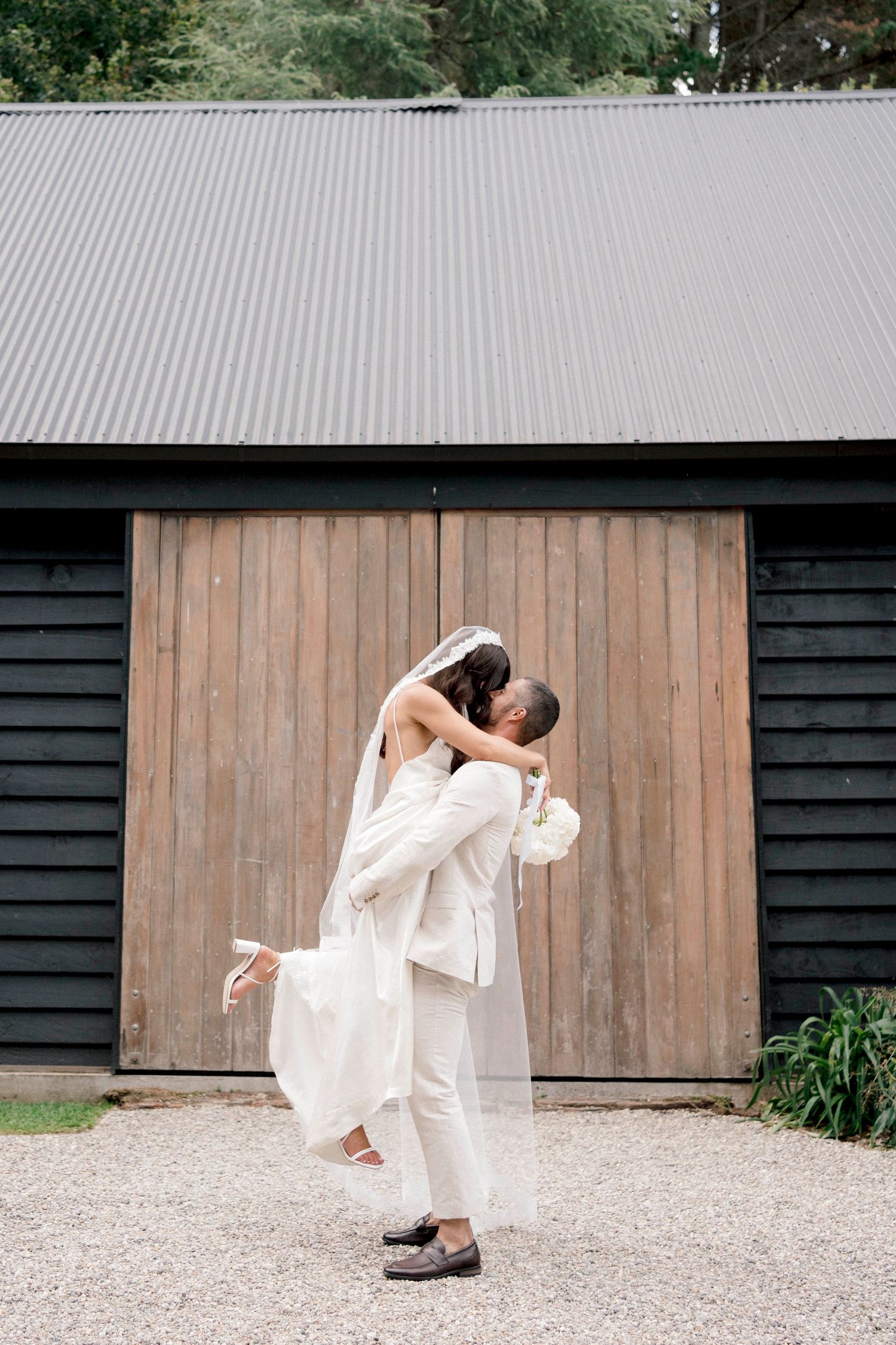 A playful dance sequence against a rustic barn backdrop with flowing white dress.