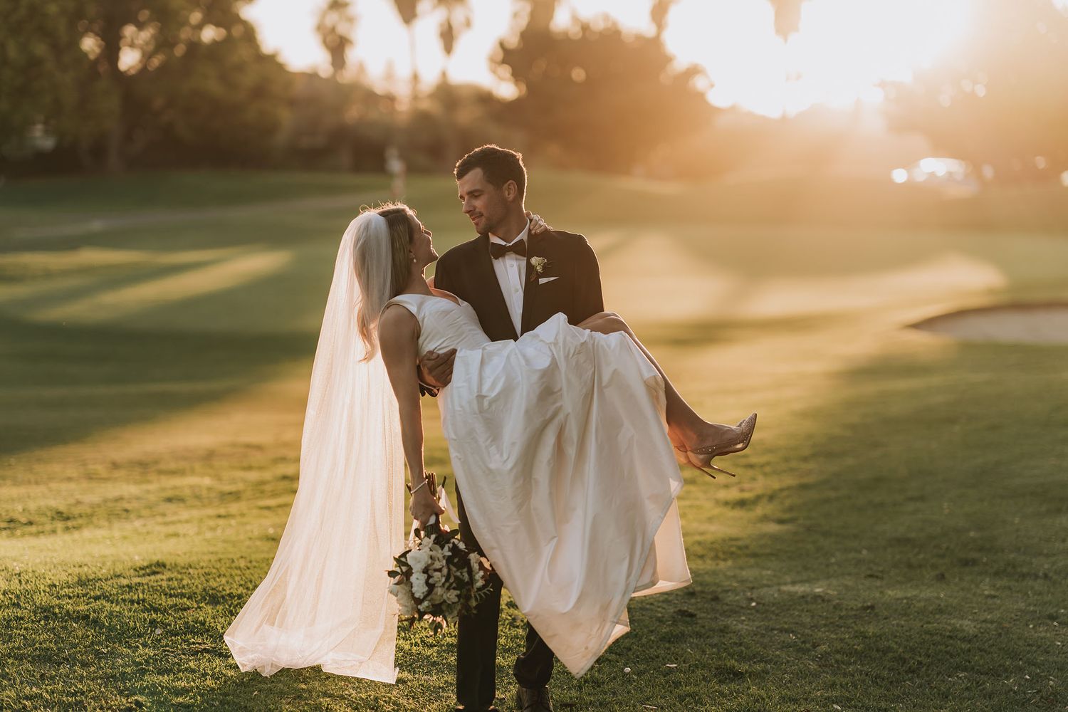 A romantic sunset wedding photo series shows a couple celebrating their special day on a lush golf course.
