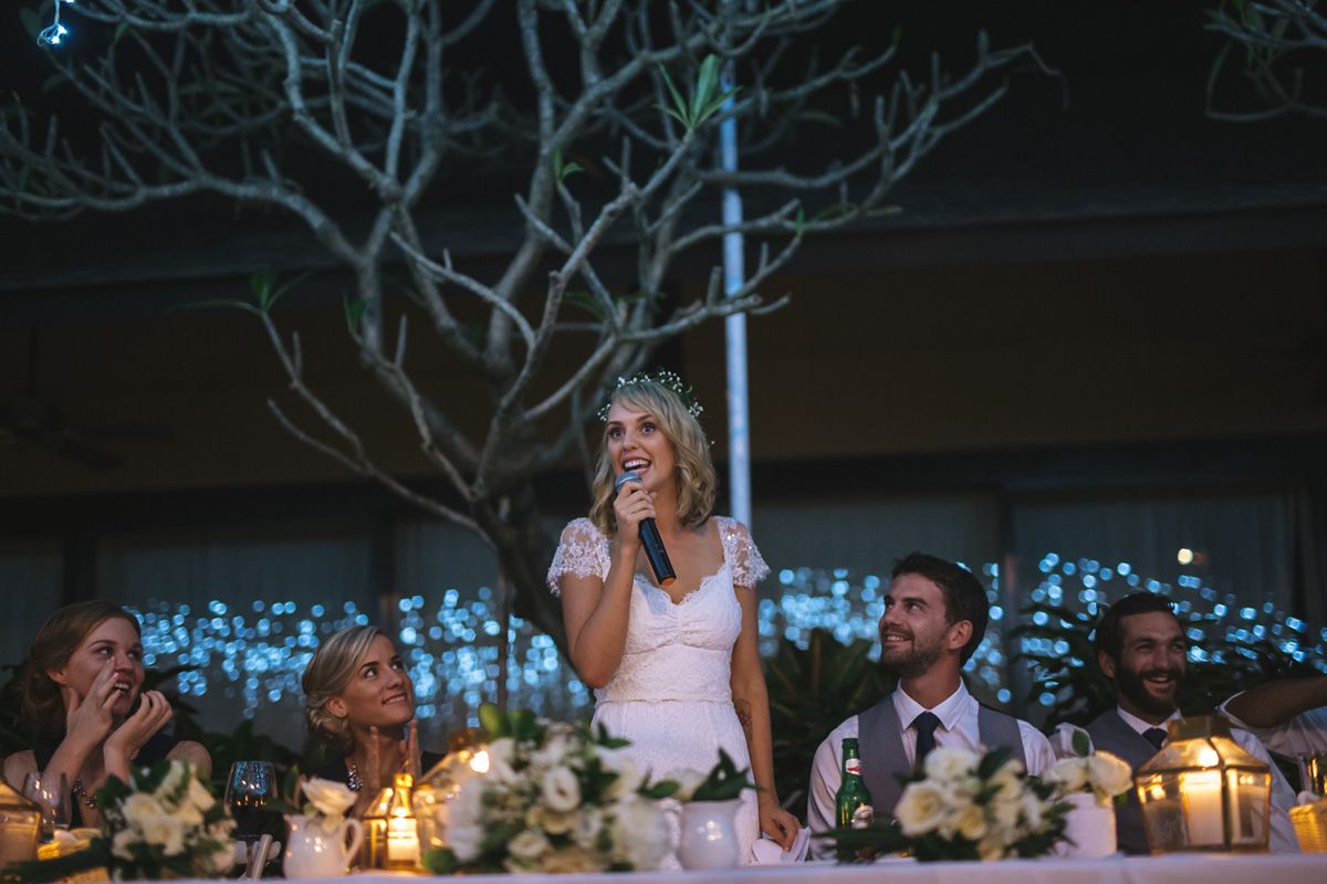 Reception dinner scene with candlelight and twinkle lights creating romantic ambiance.