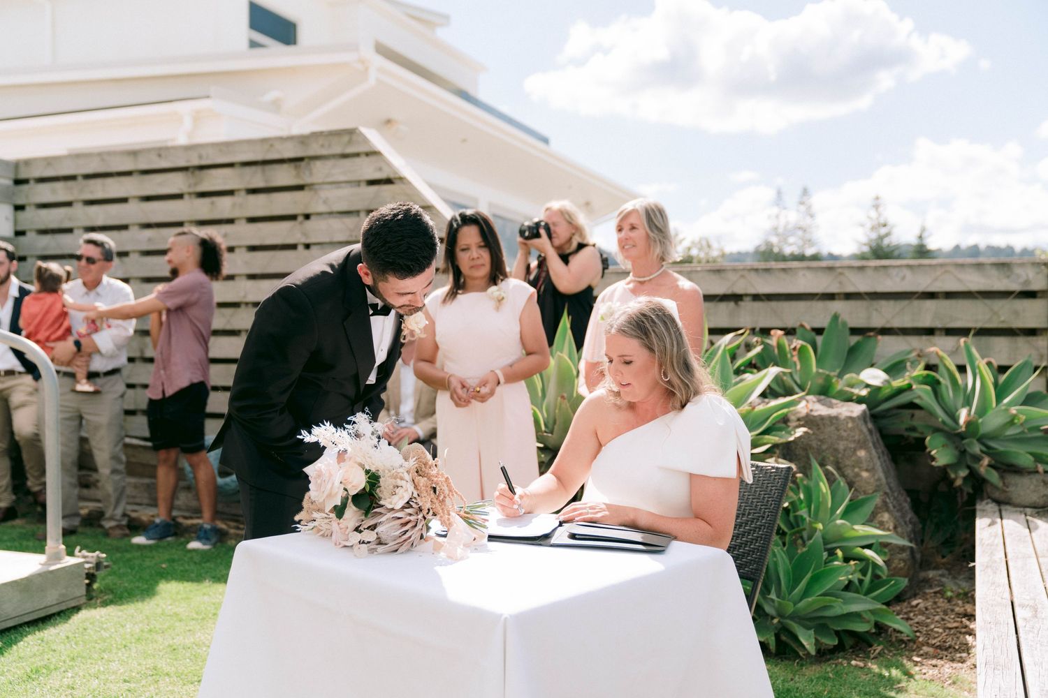 Wedding ceremony setup with white chairs overlooking a mountainous landscape.