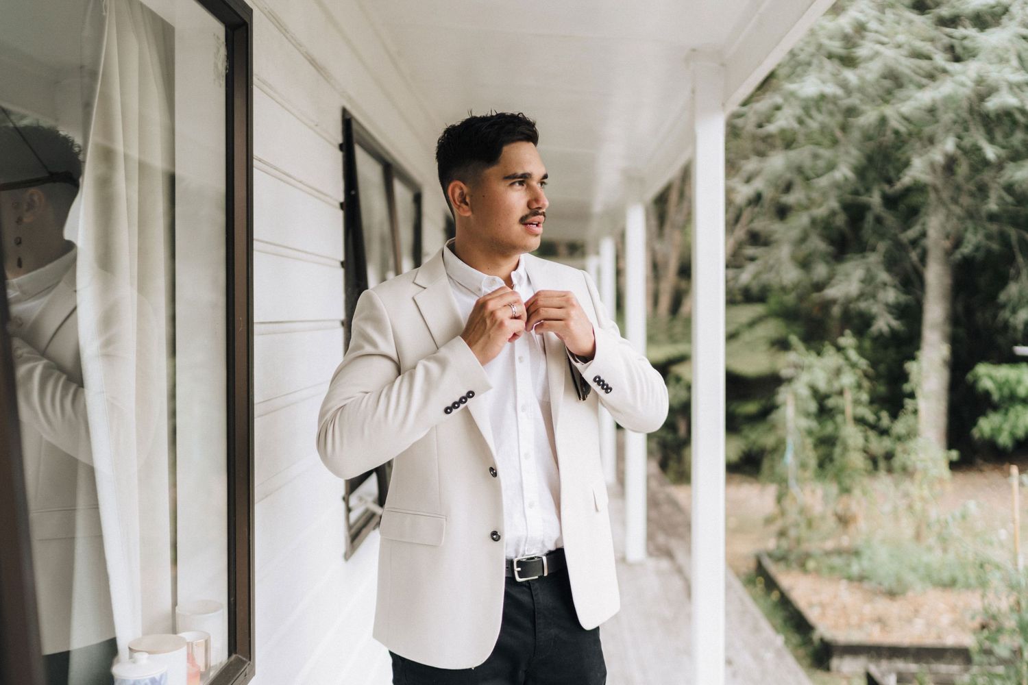 Elegant wedding preparation scene along a white columned porch.