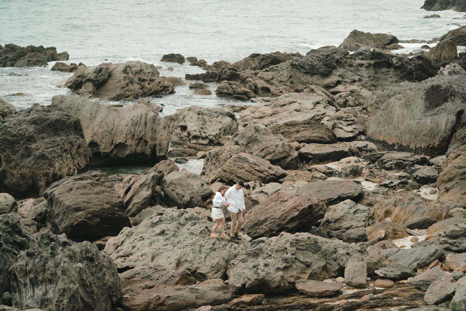 Dramatic coastal rock formations stretching along the shoreline.