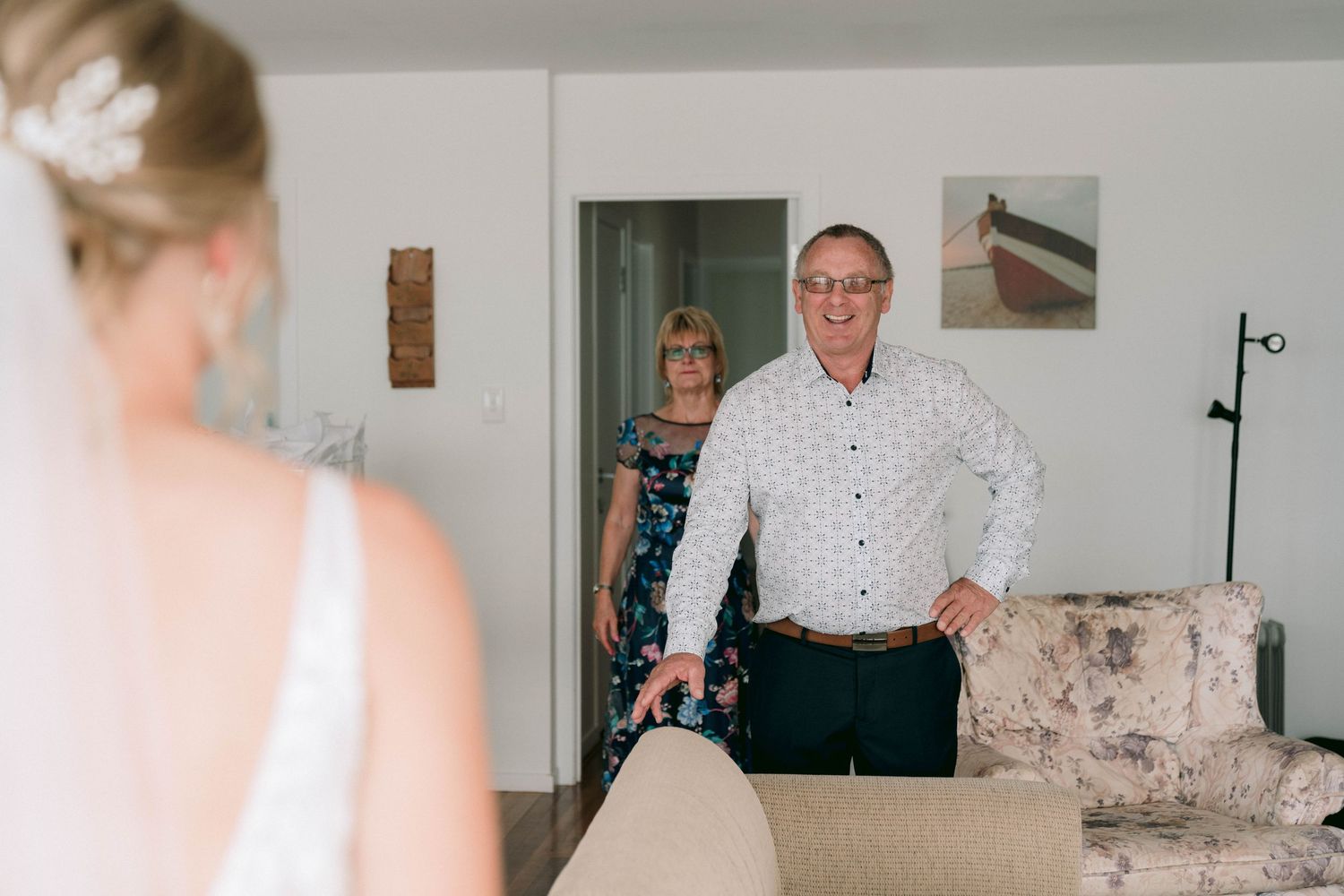 A sweet and emotional moment during wedding preparations as people share a heartfelt first look in a brightly lit room.