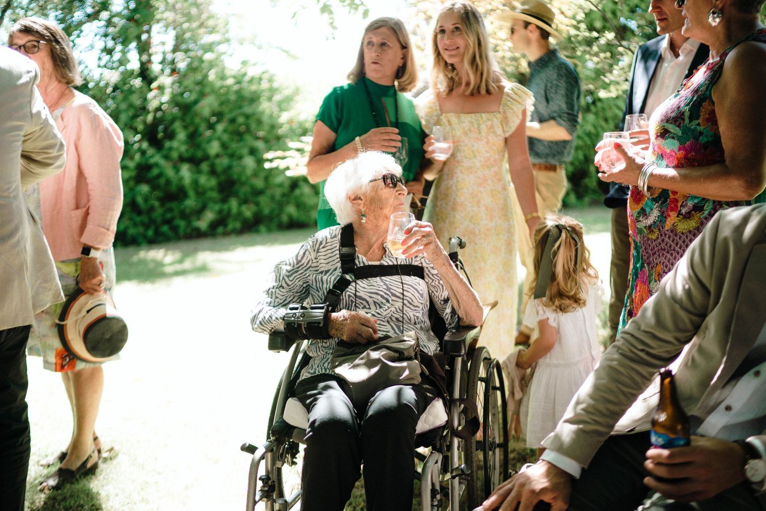 Guests mingle and socialize at an outdoor garden party event with refreshments.