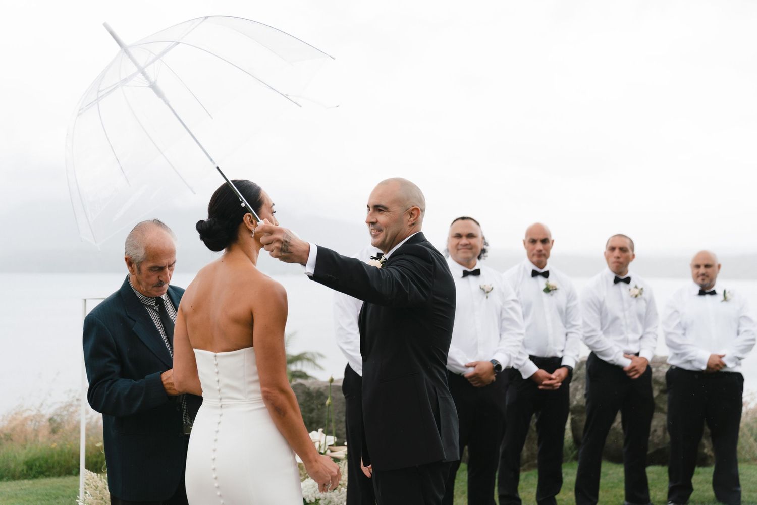 A candid black and white sequence of moments from a beachside wedding ceremony captured in a film strip style.