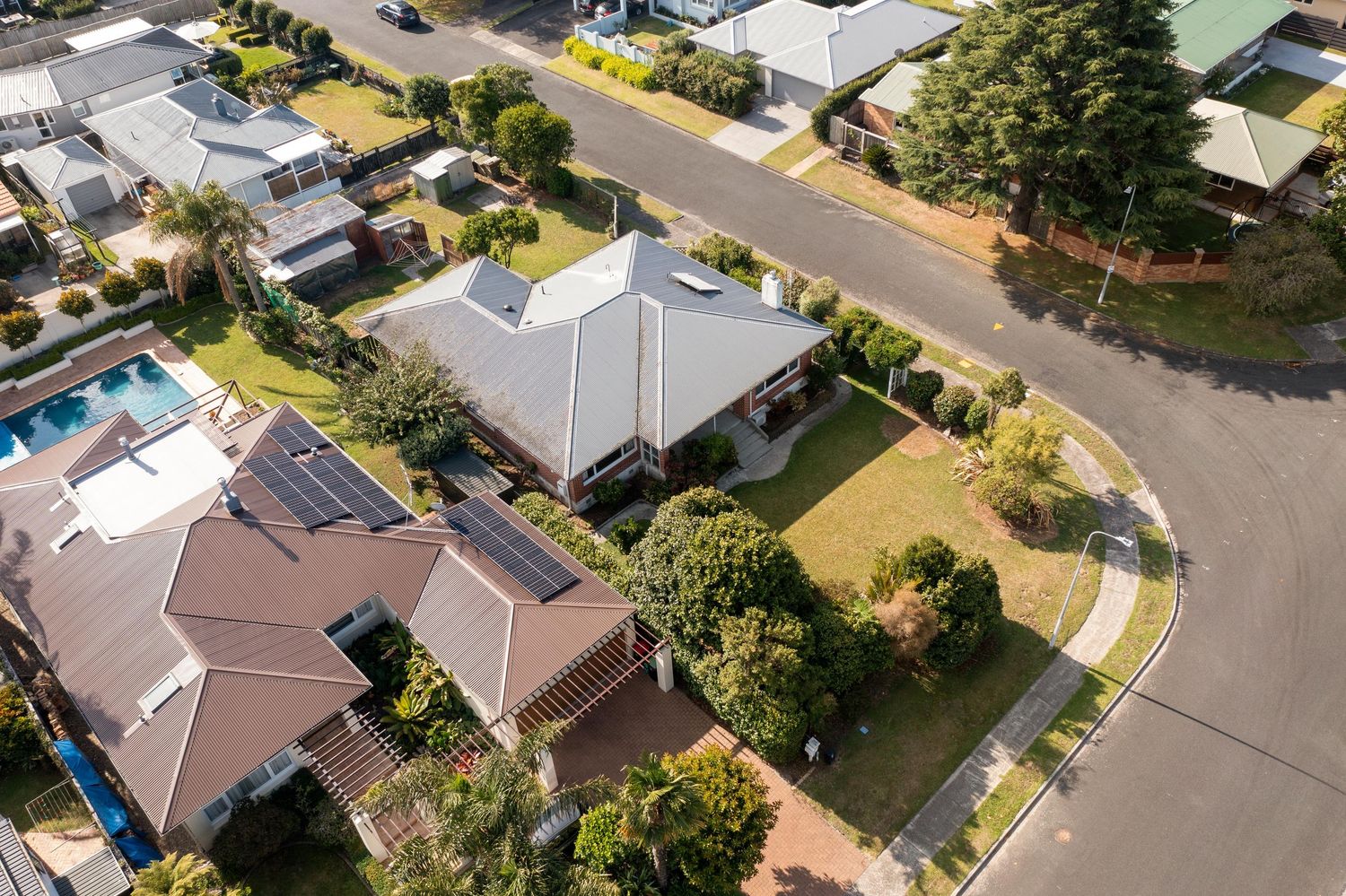Aerial view of suburban neighborhood showing houses and streets from above.