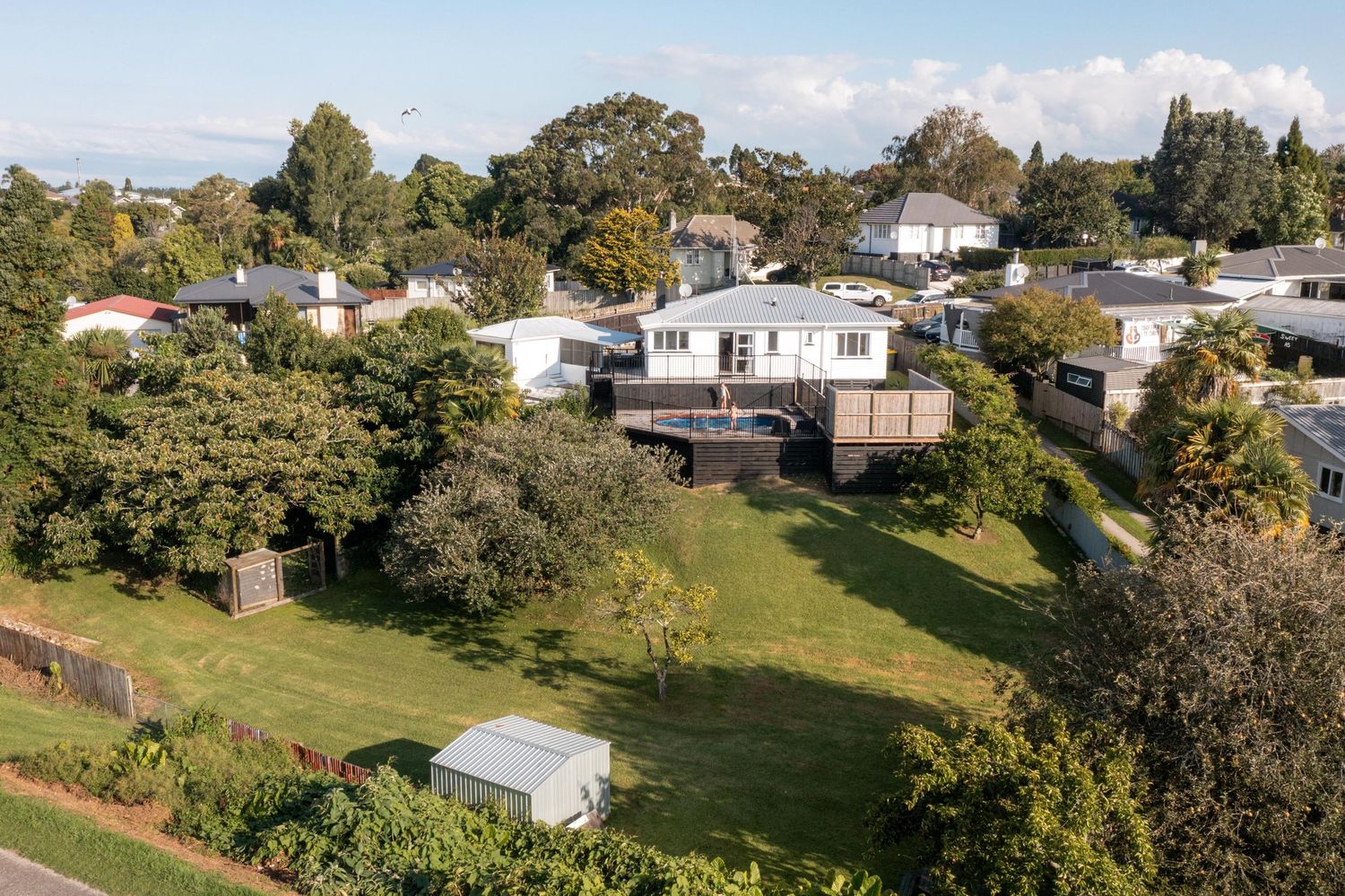 Aerial panorama of suburban neighborhood with houses and green spaces.