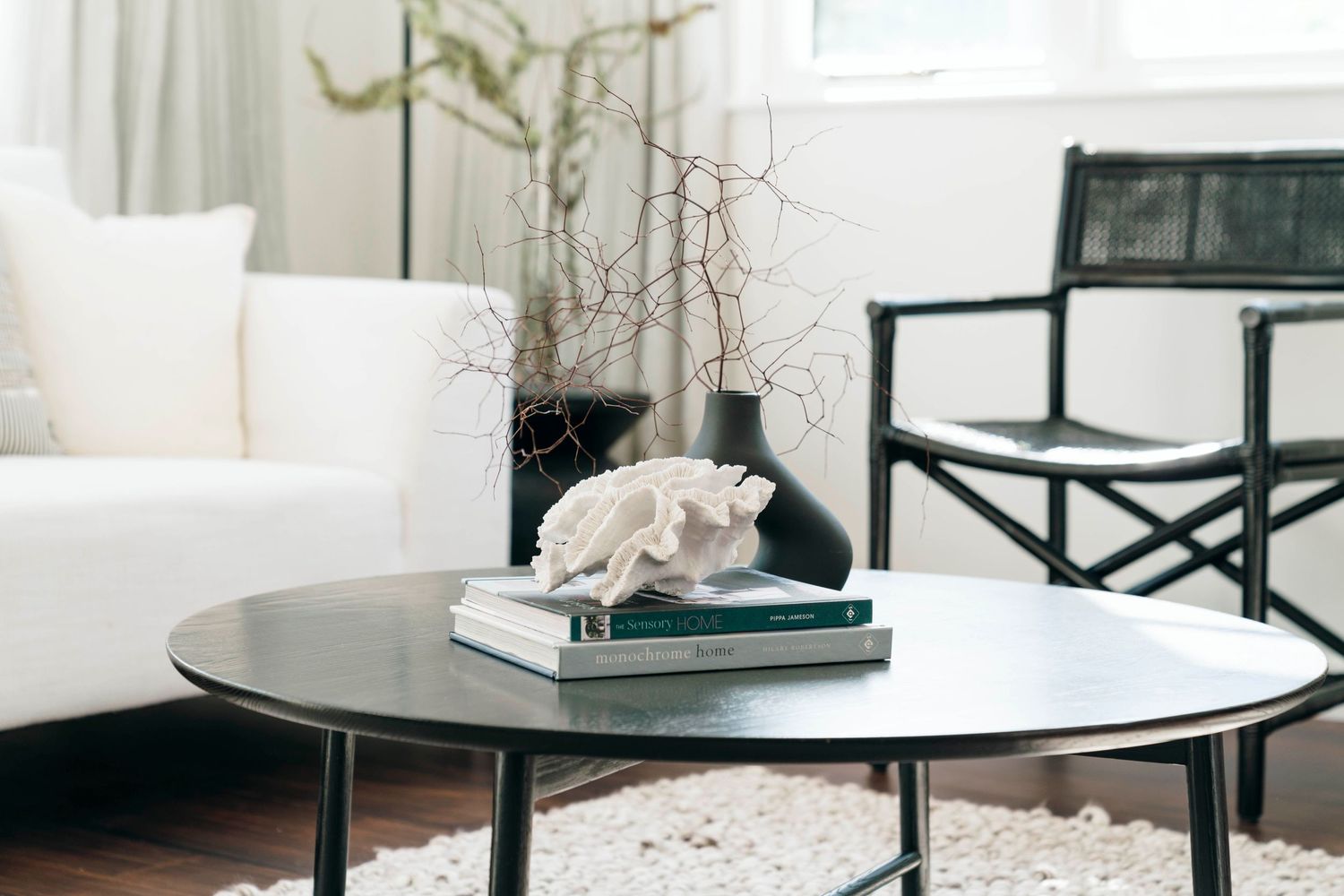 Modern living room with white sofa and contemporary round coffee table.