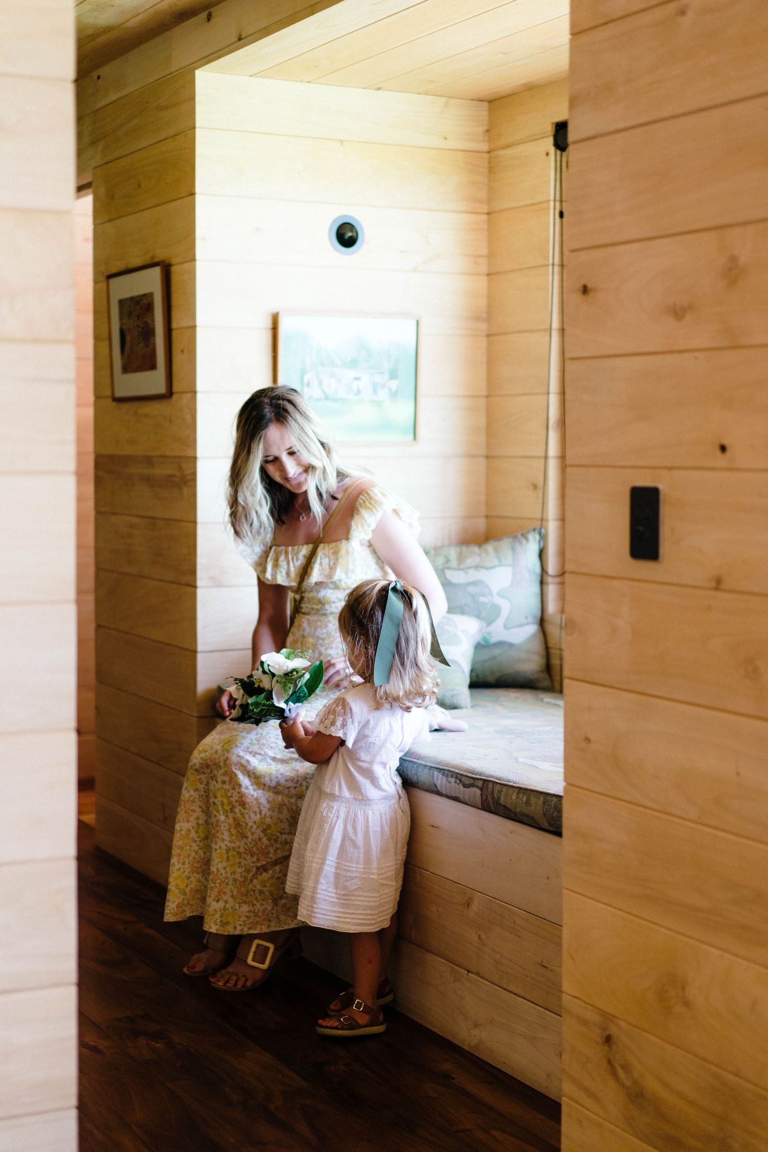 Four artistic photos showing playful moments in a wooden-paneled room with window nooks.