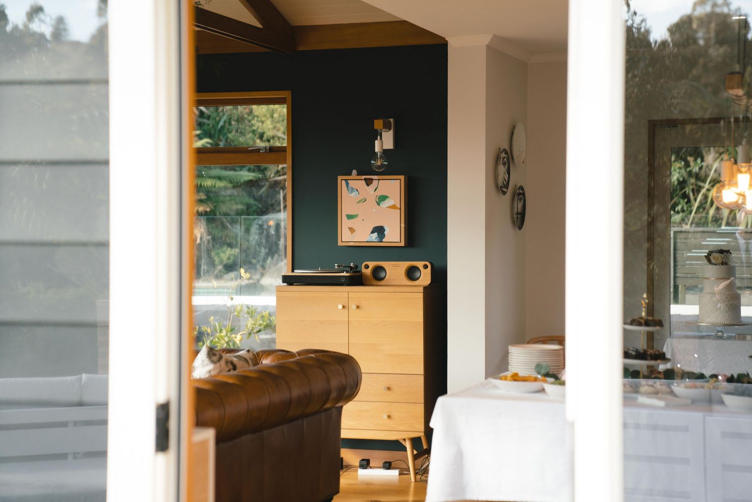 Modern farmhouse interior showing bright white walls and wooden cabinetry in an open-concept living space.