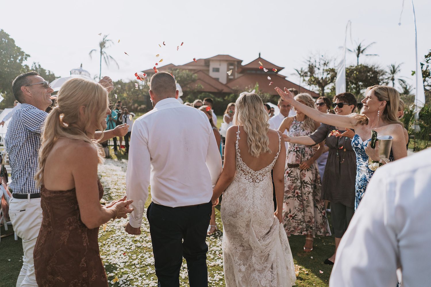 Wedding celebration with confetti toss during outdoor garden reception.