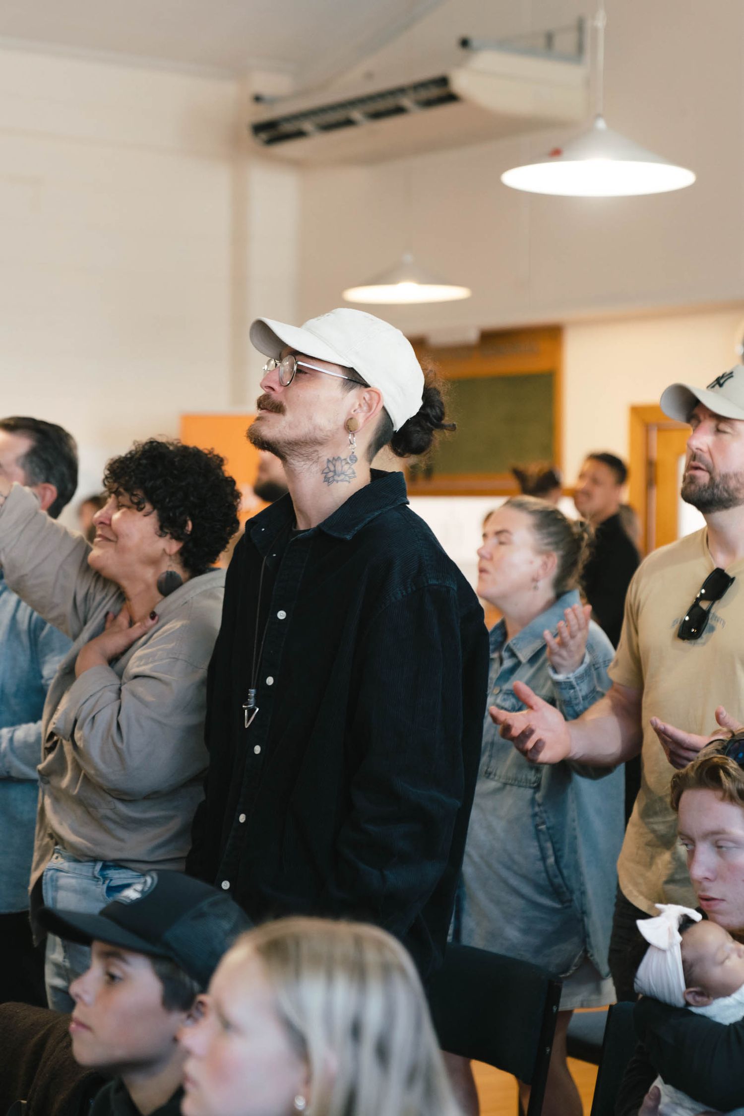 Crowd of people watching intently in an indoor venue.