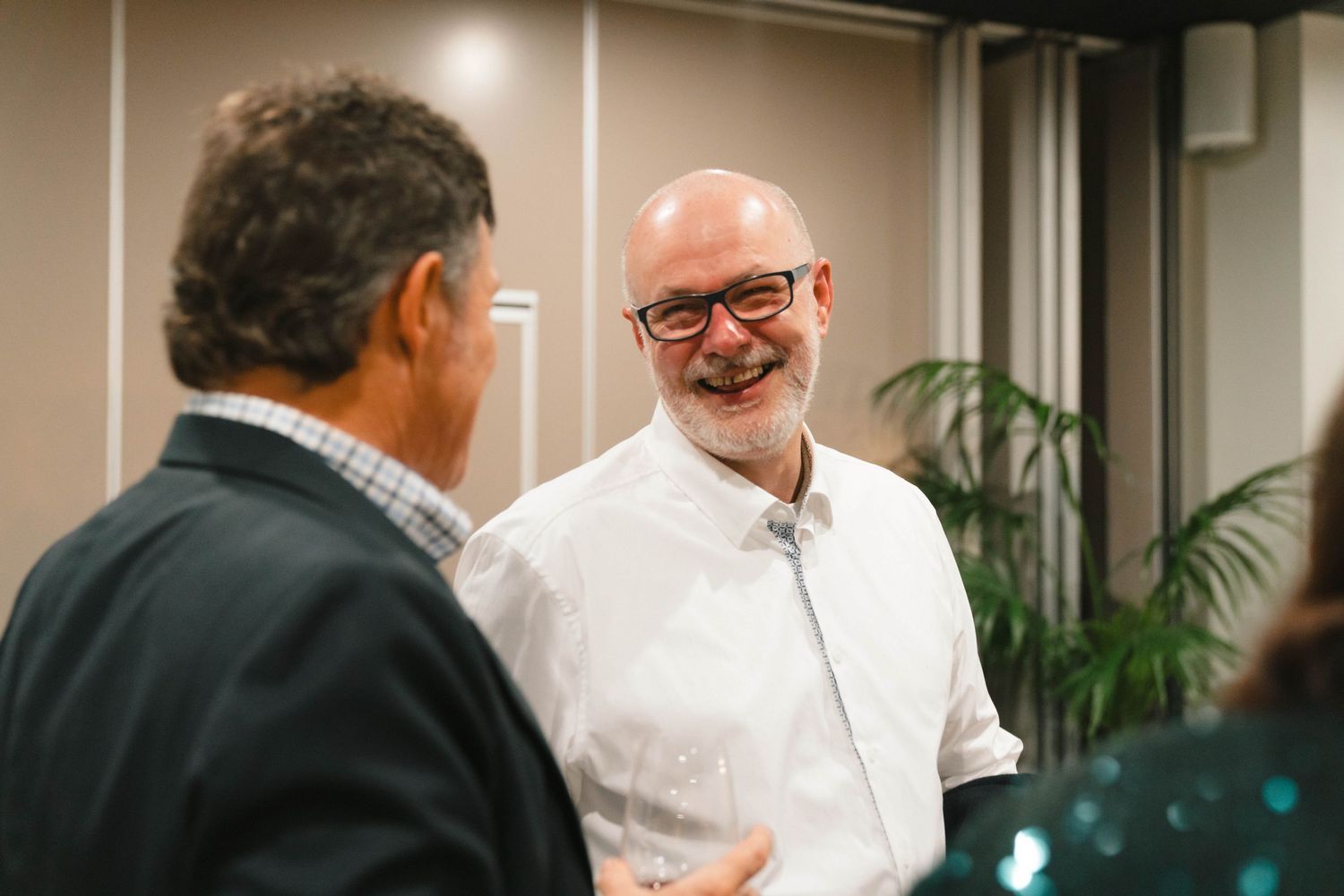 Professional networking event showing attendees engaging in conversation.