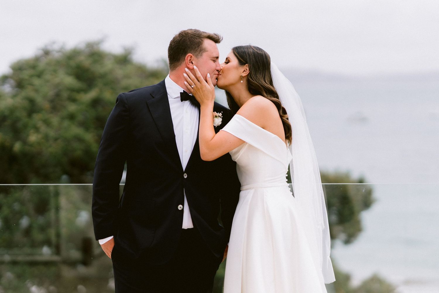 A romantic wedding ceremony moment captured against a scenic mountain backdrop.