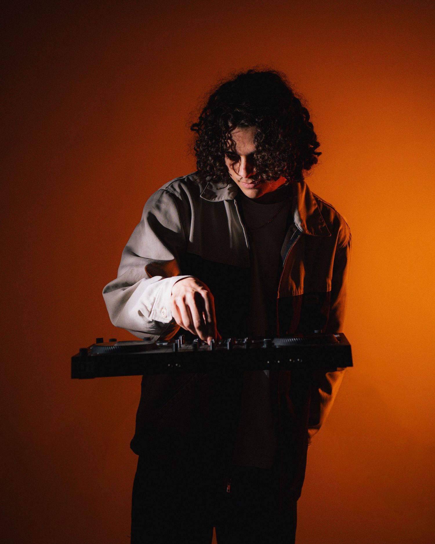 A sequence of moody portraits showing silhouetted figure with curly hair against warm orange lighting.