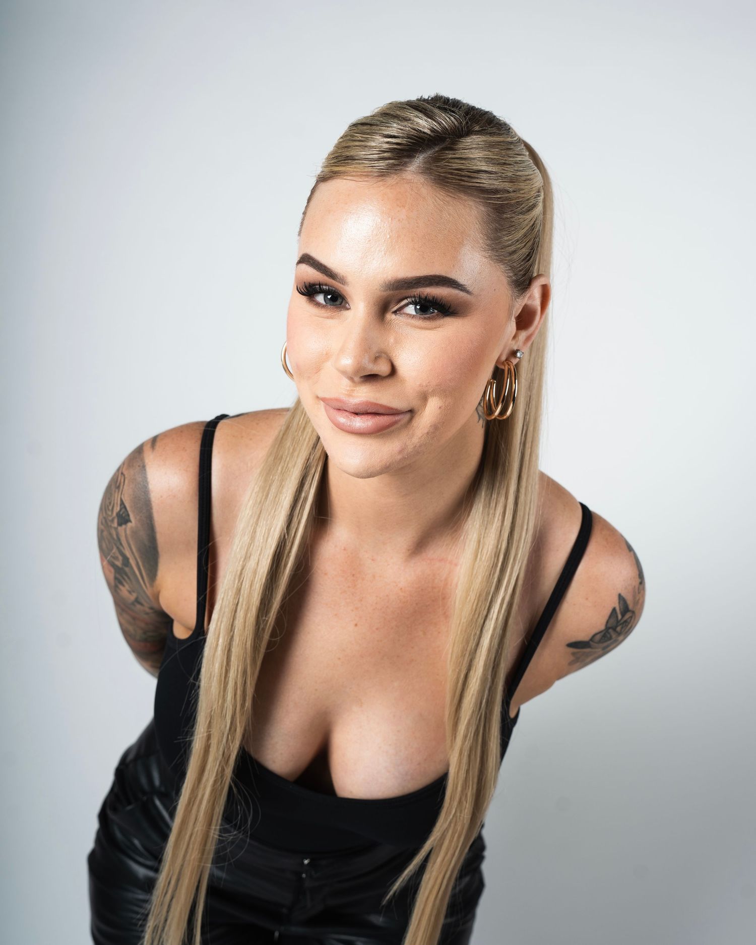 Portrait series showing a person posing in casual attire against a light gray studio backdrop.