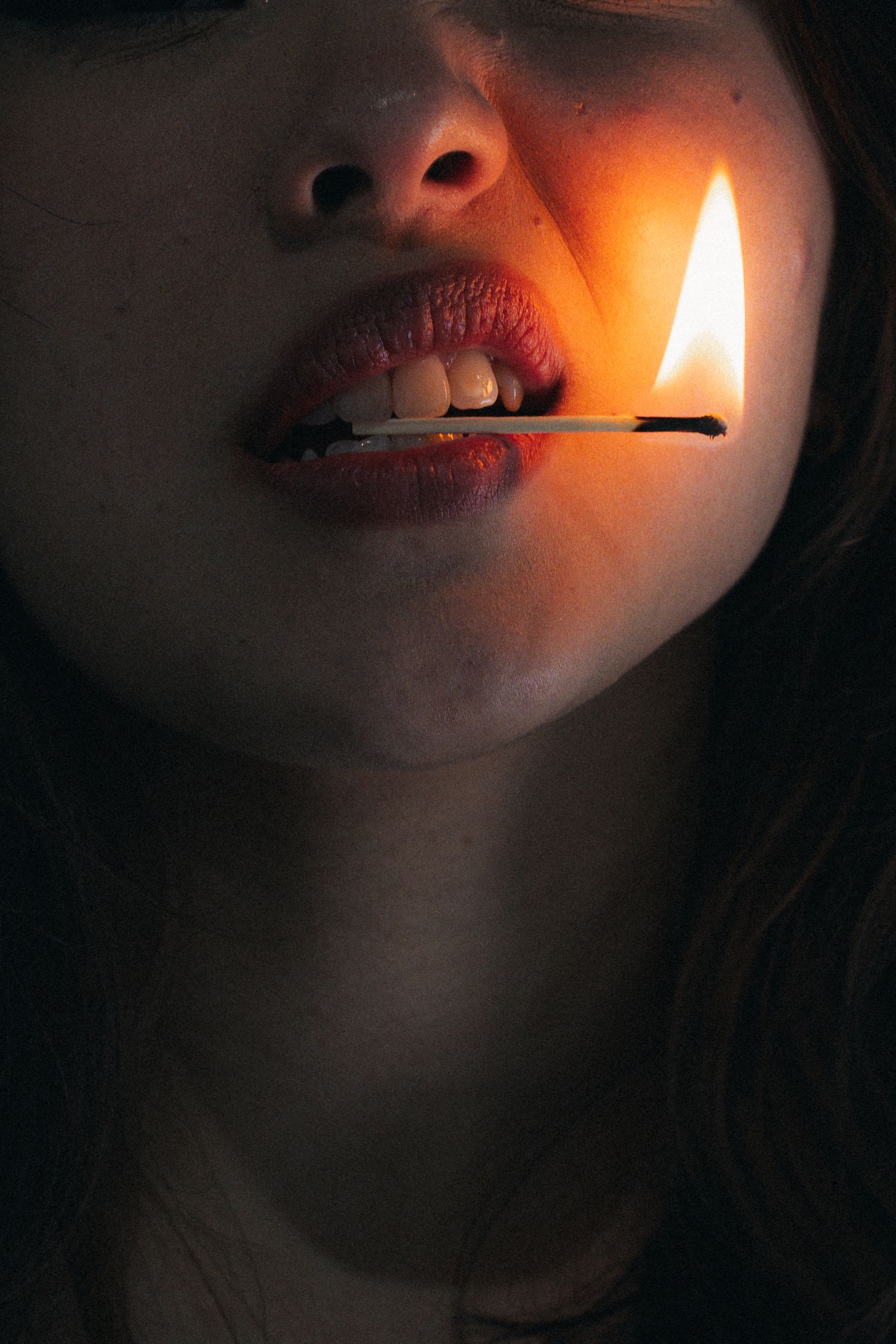 A dark and moody photo sequence shows someone lighting a cigarette with dramatic lighting against a black background.