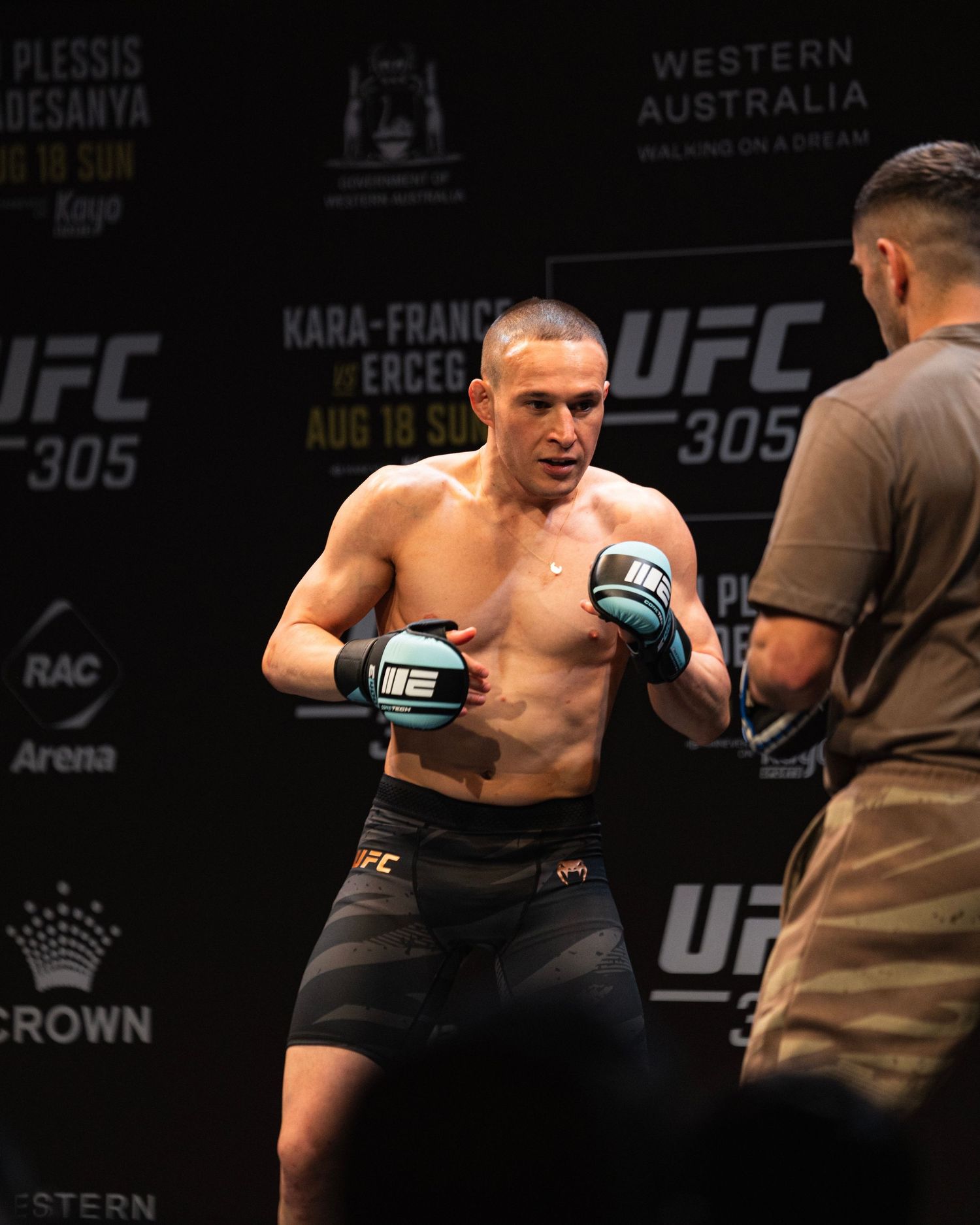 UFC fighter in fighting stance during weigh-in event at RAC Arena.