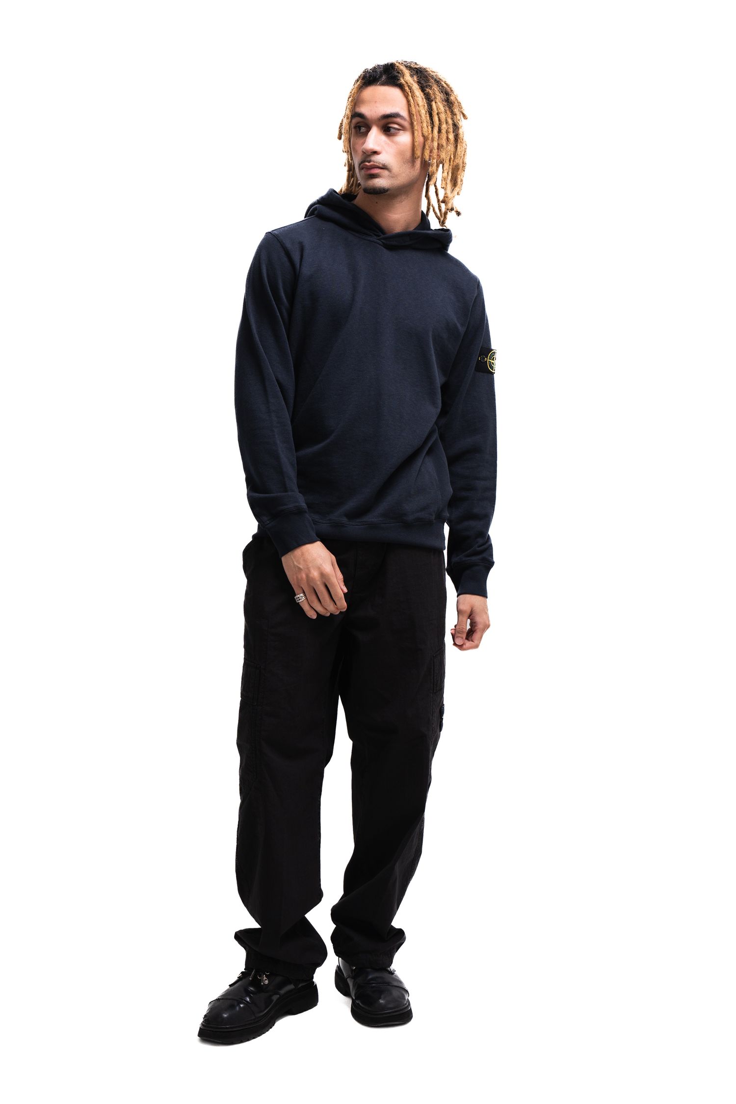 Classic navy blue hoodie paired with black pants and dark shoes.