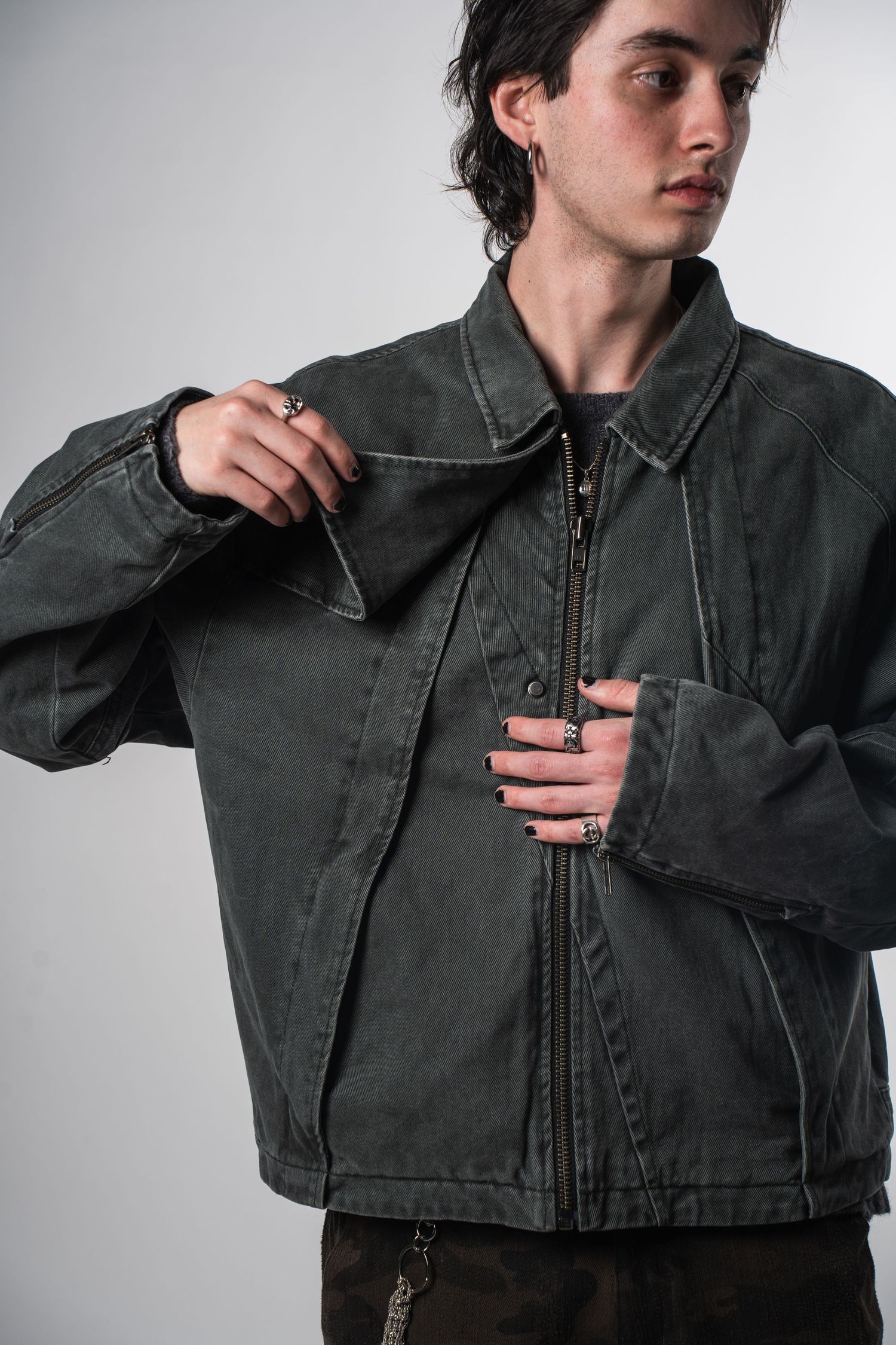 Model wearing oversized charcoal denim jacket with zip front closure.