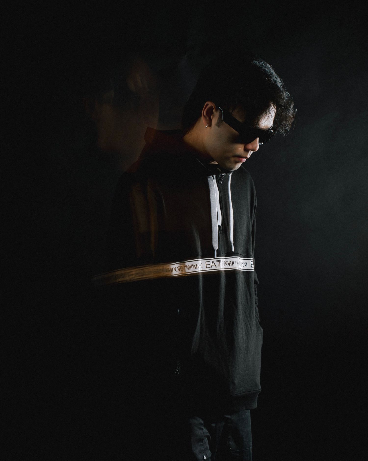 Artistic low-light photography sequence showing a person in dark clothing against dramatic shadows and moody lighting.