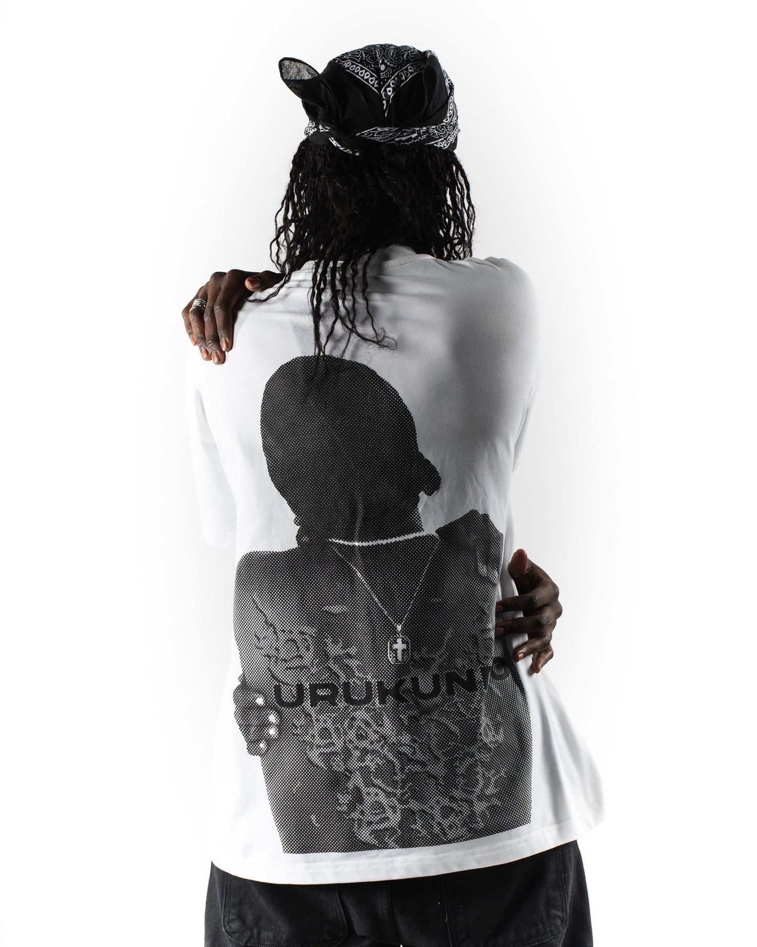 Back view of person wearing white t-shirt with black graphic print design.