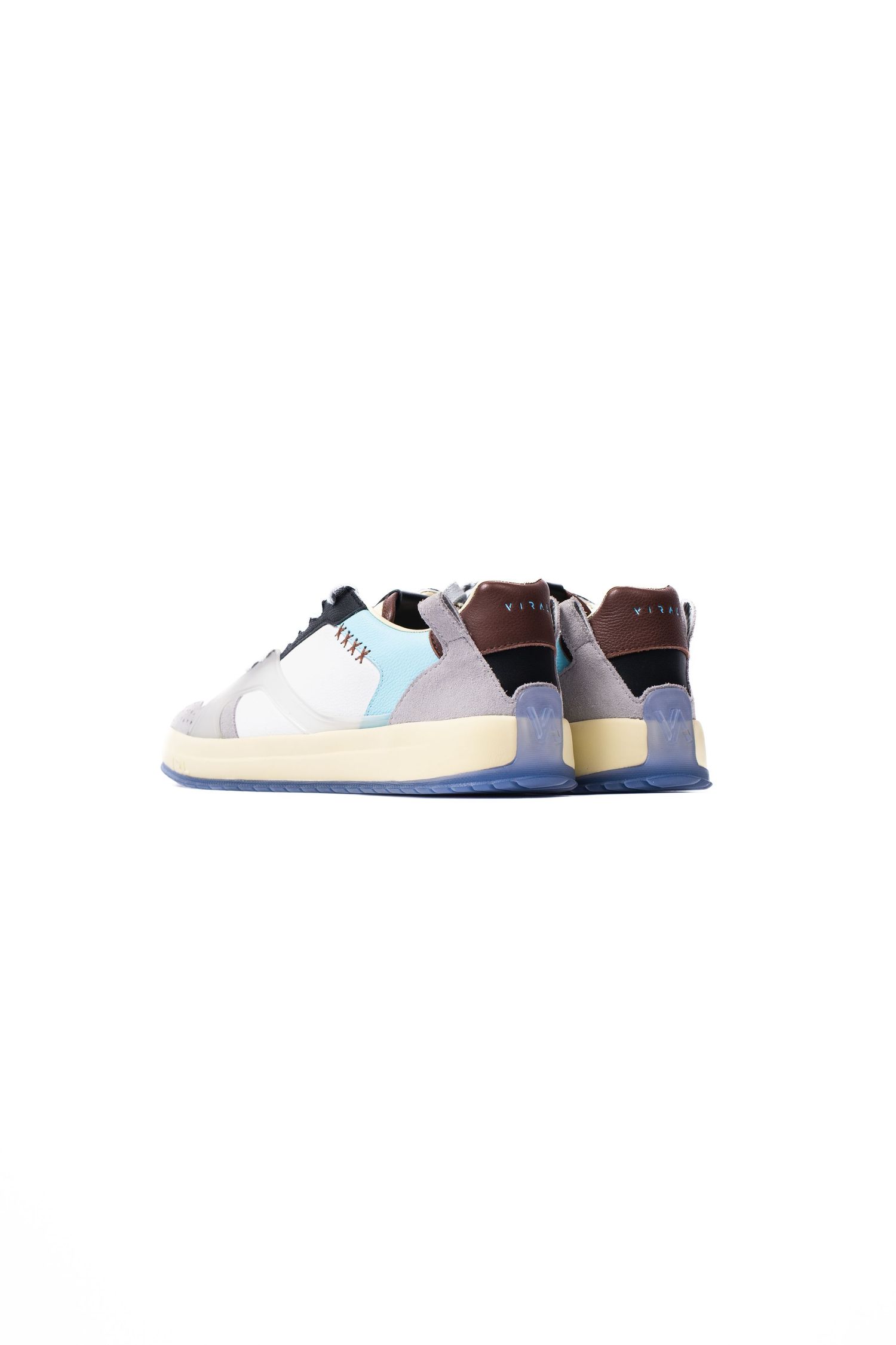 Designer sneakers with pastel blue and gray color blocking on white sole, viewed from side angle.