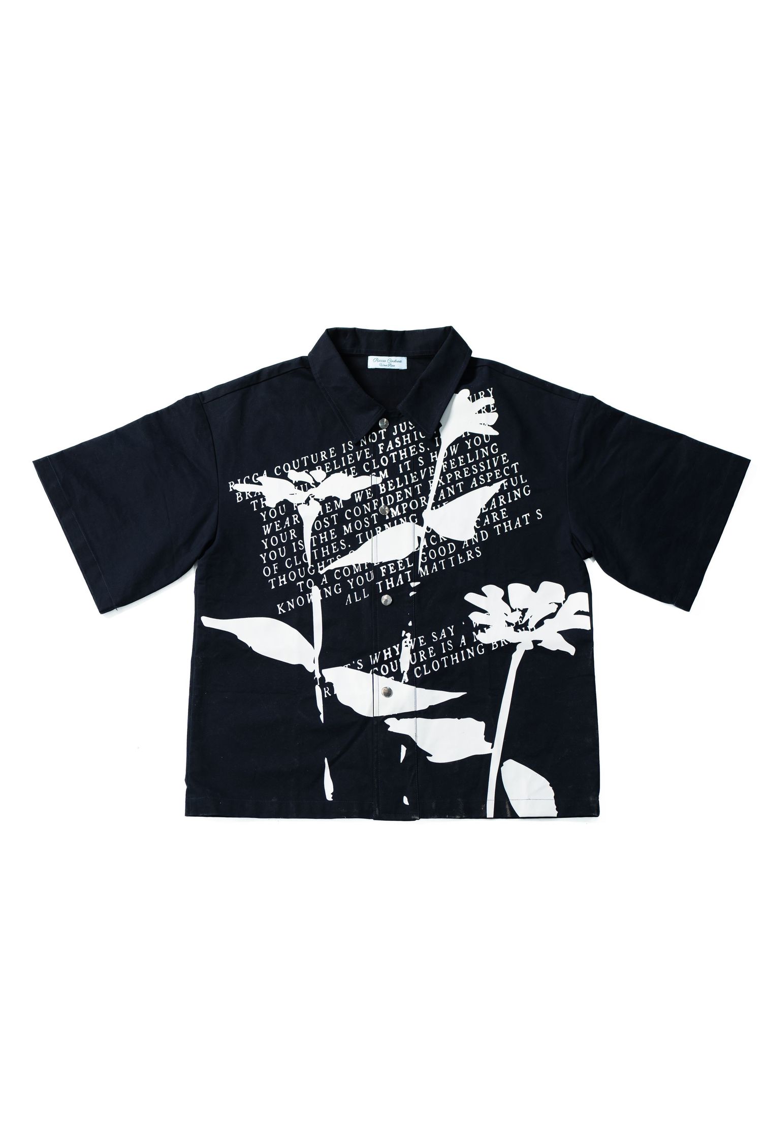 Black button-up shirt with white floral and text graphic print design.