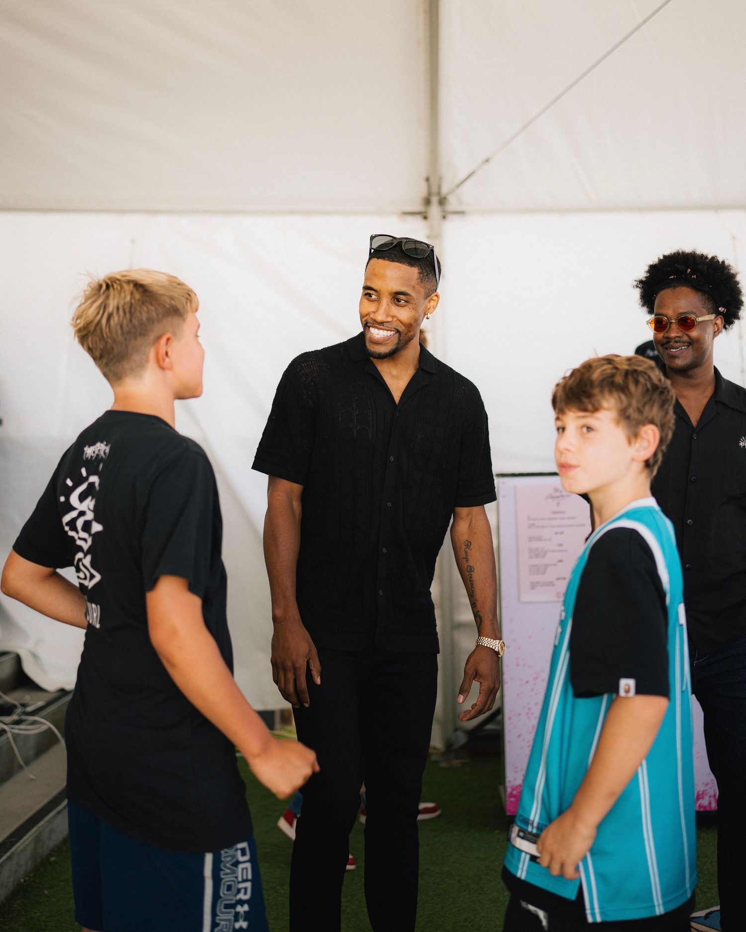 Young fans interact with athletes at casual meet and greet event.