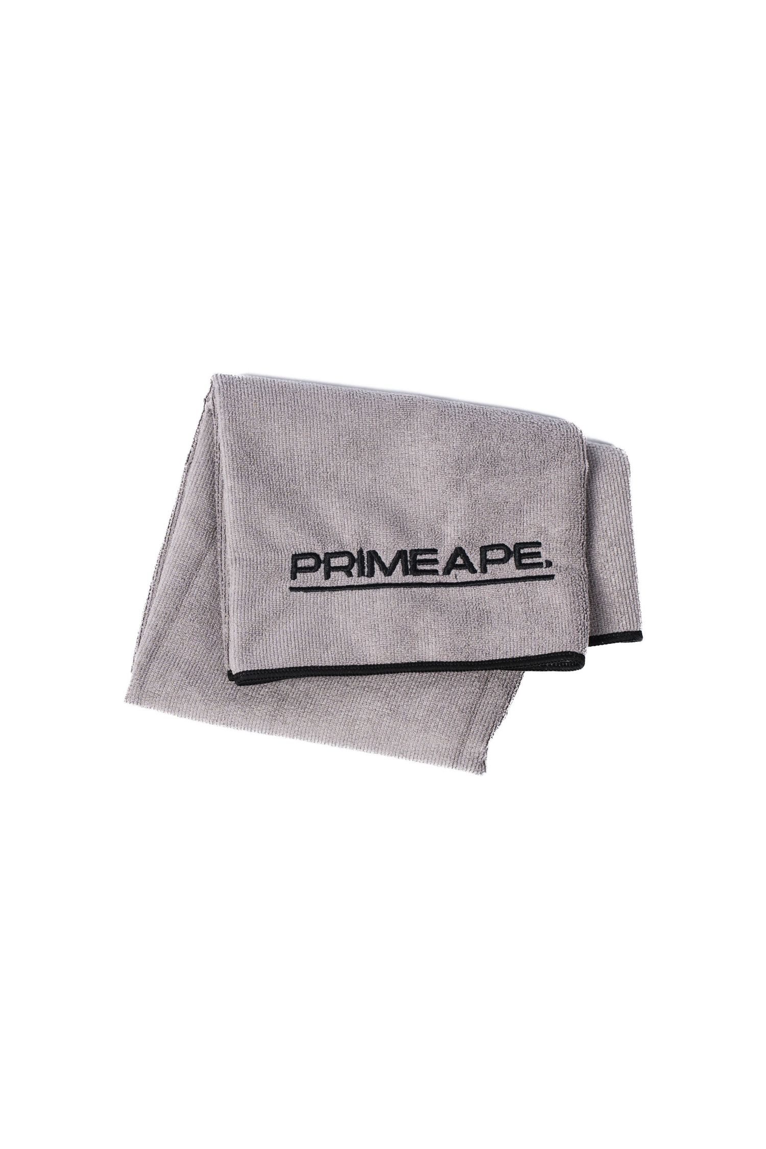 A soft gray microfiber workout towel with black PRIME APE logo text embroidered on one corner.