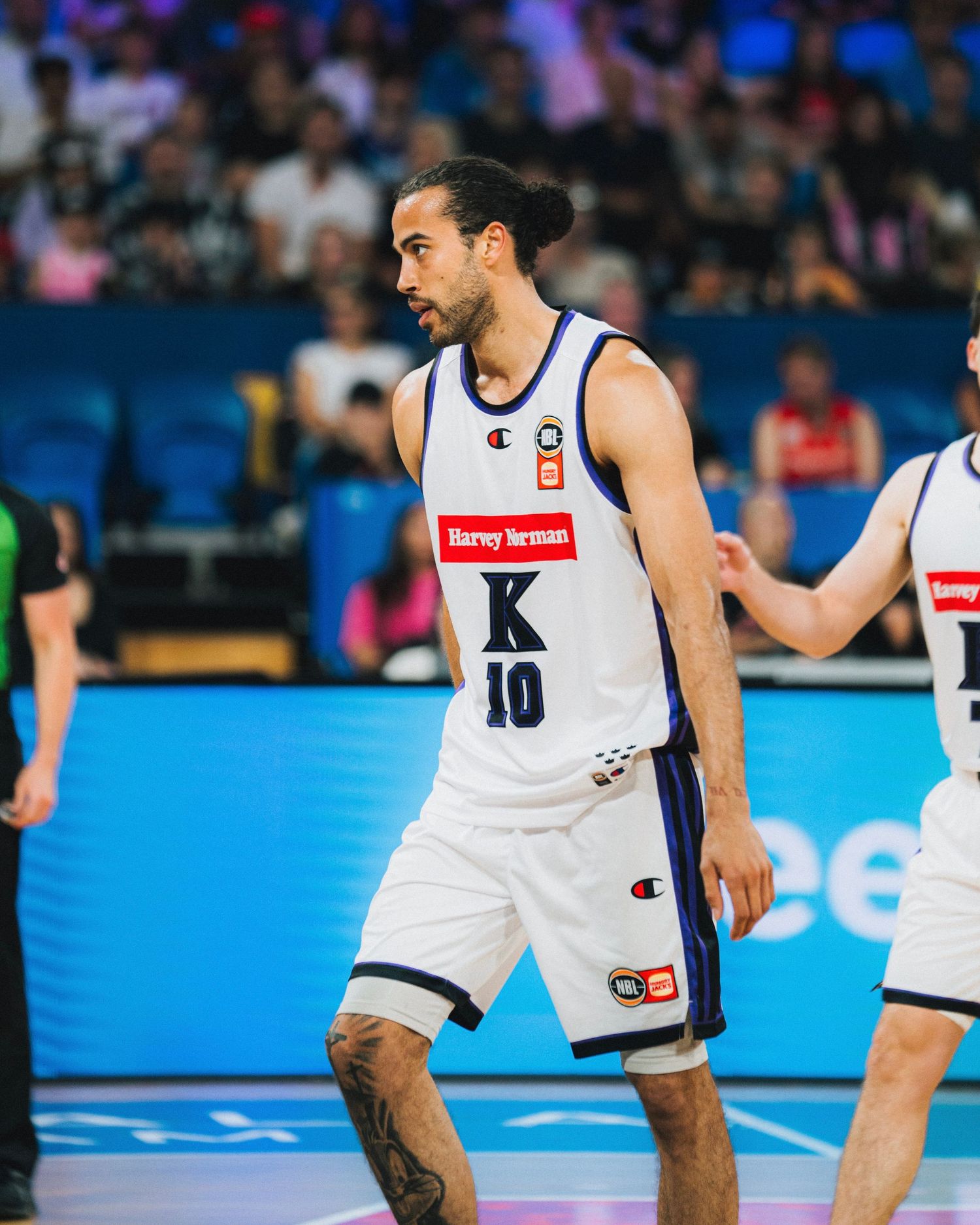 Basketball player wearing white jersey with number 10 during professional game.
