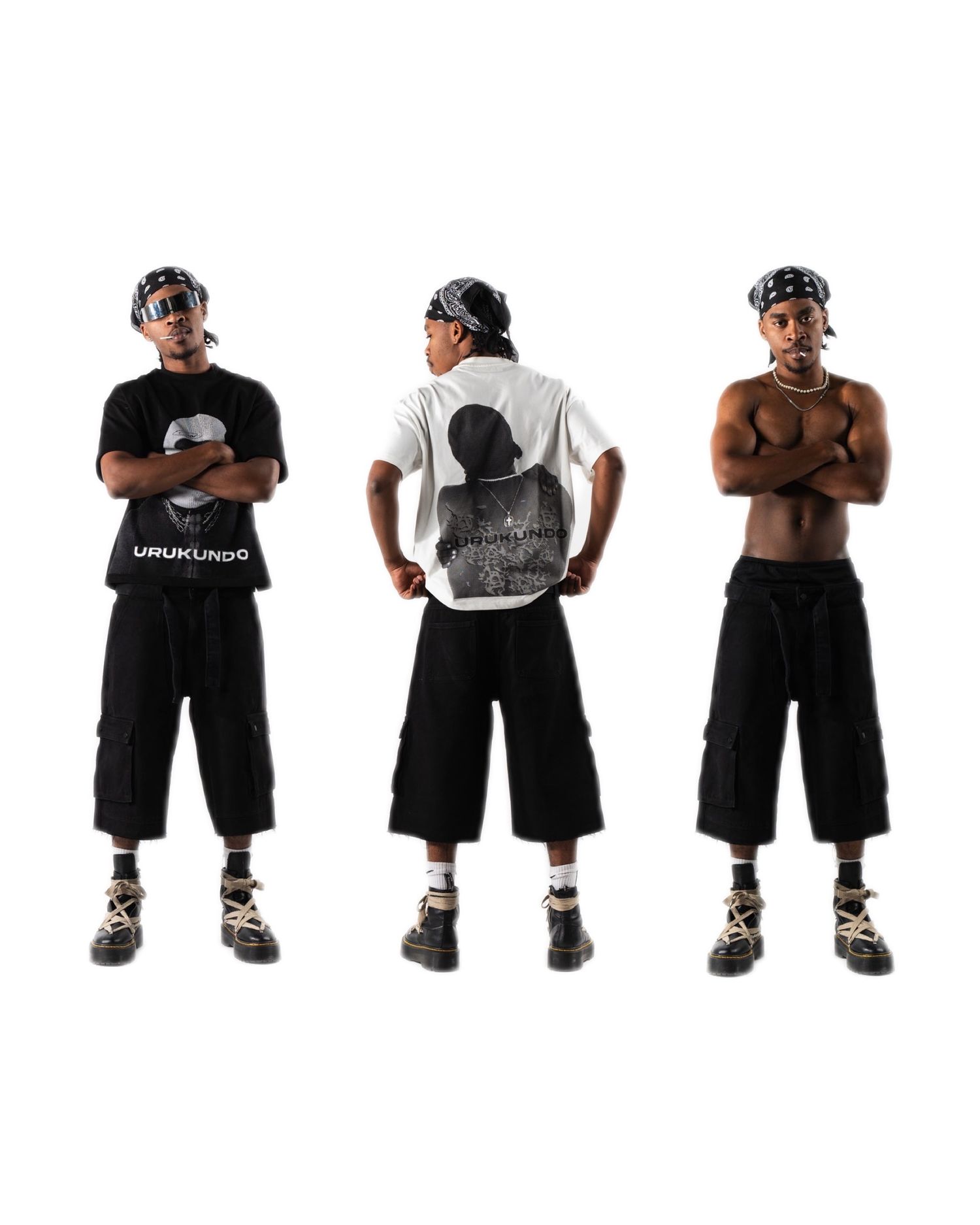 Three people in black clothing striking poses against white backdrop.