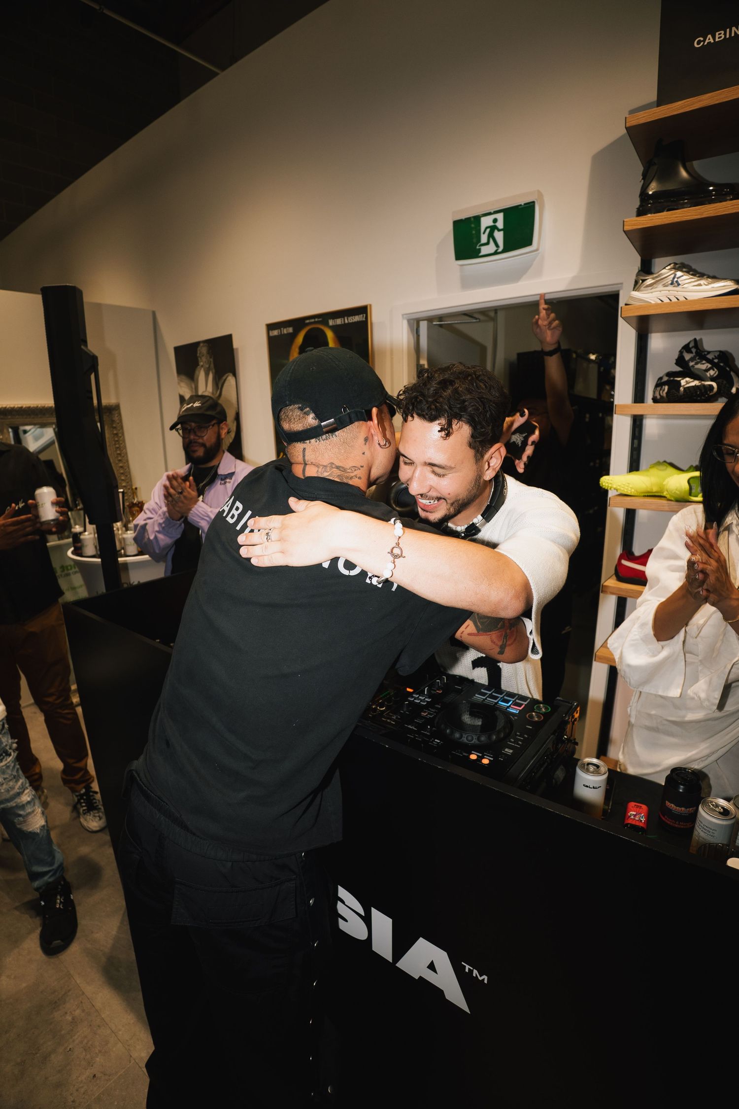 Celebration moment at SIA retail store with people embracing and cheering.