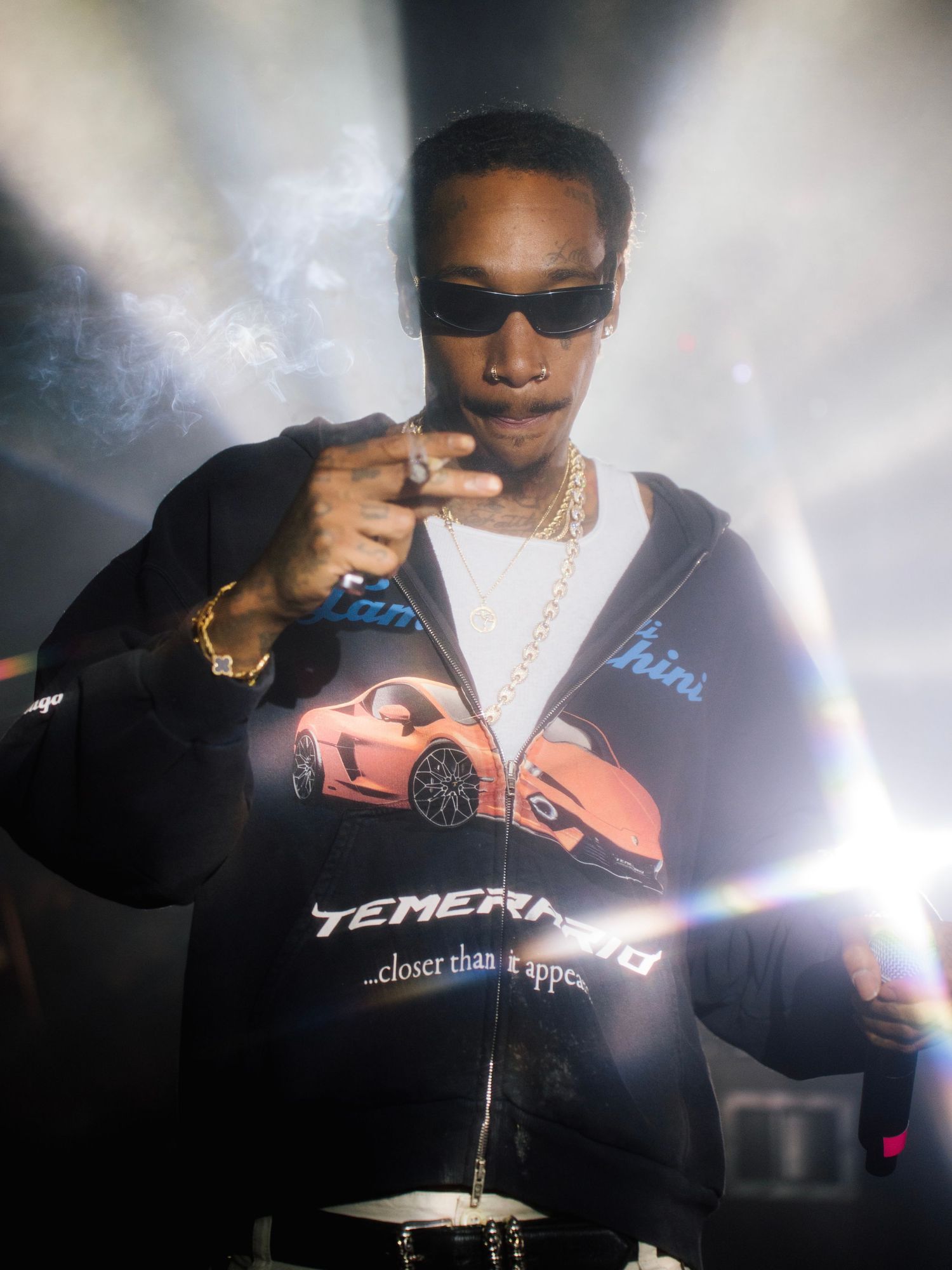 A series of photos showing someone in sunglasses and a black t-shirt smoking in dramatic lighting.