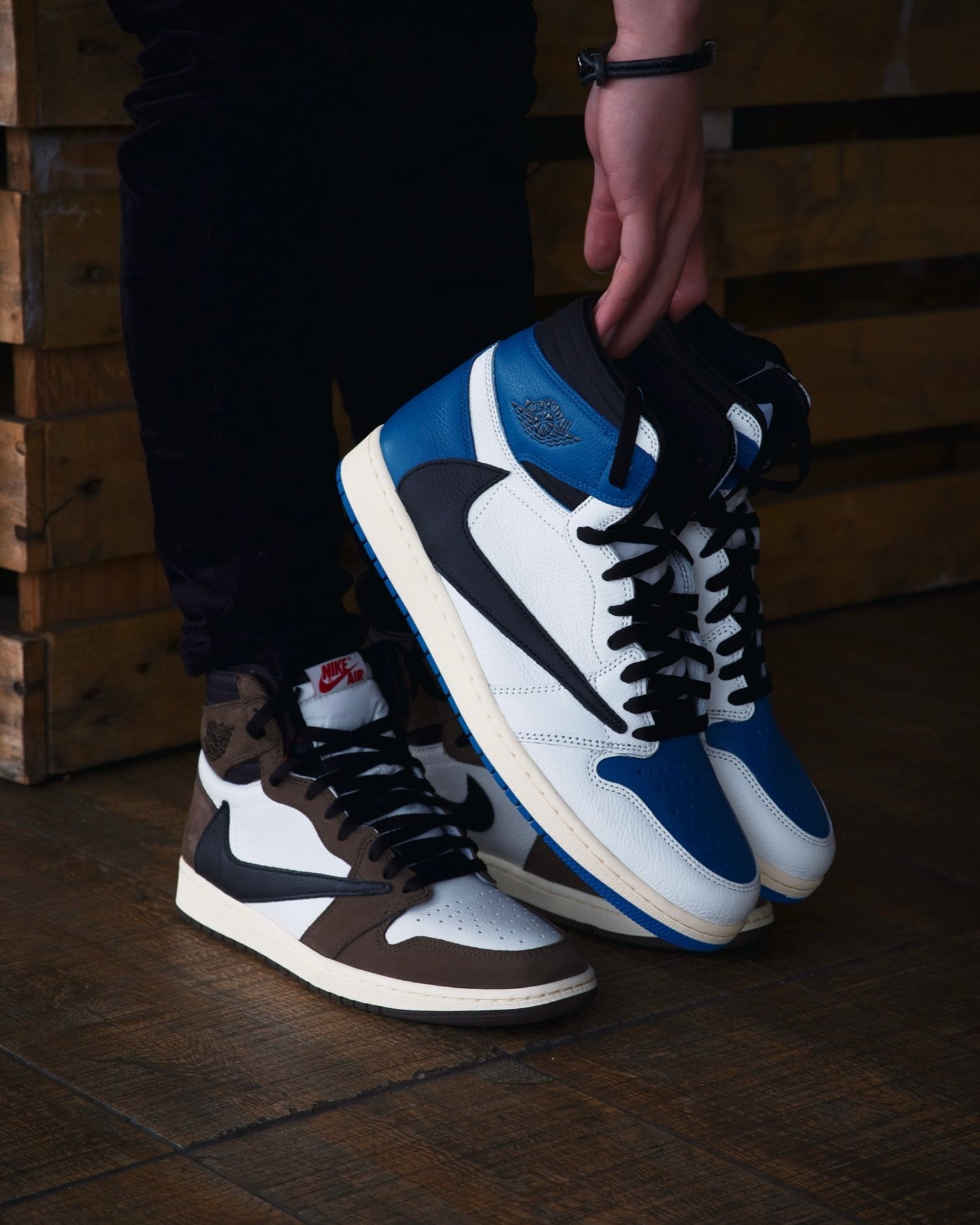 Two pairs of Nike high-top sneakers in blue and brown colorways shown against wooden crate background.