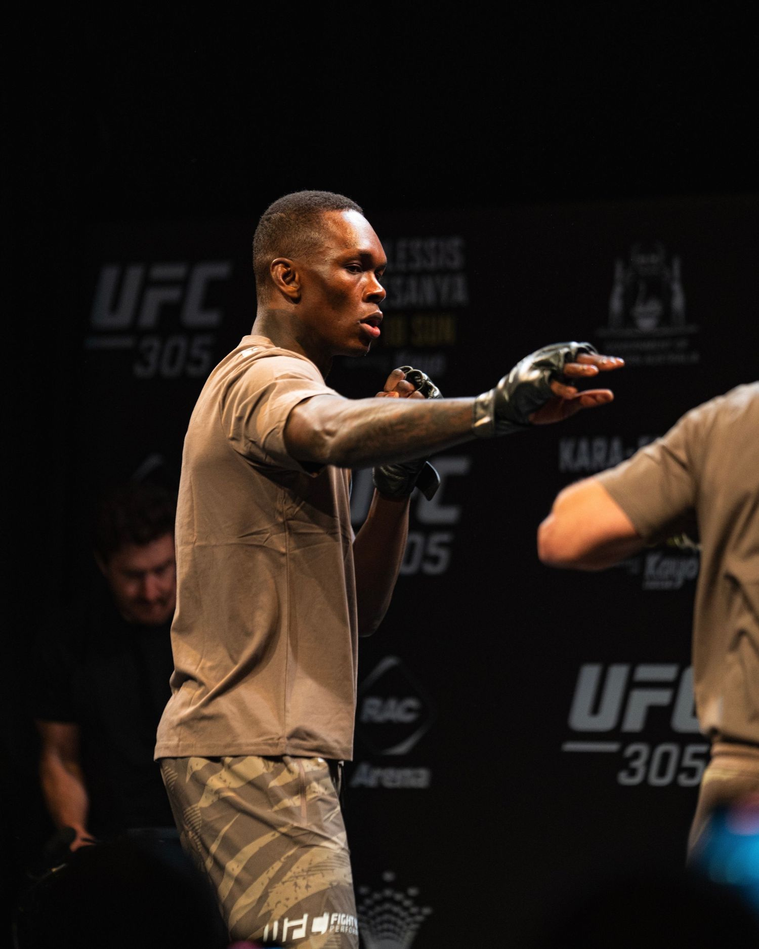 Fighter gesturing during UFC event press appearance.