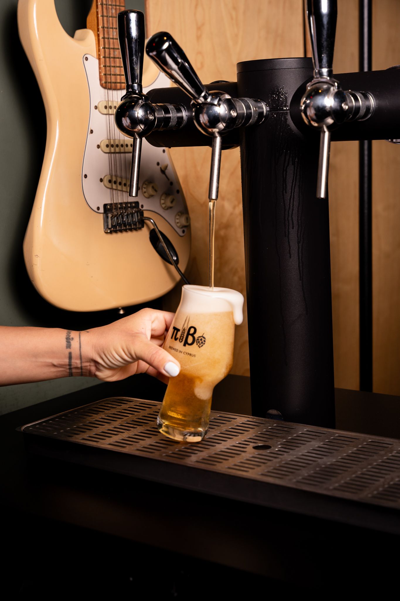 A sequence of five photos showing a beer being poured from a tap into a glass with an electric guitar in the background.