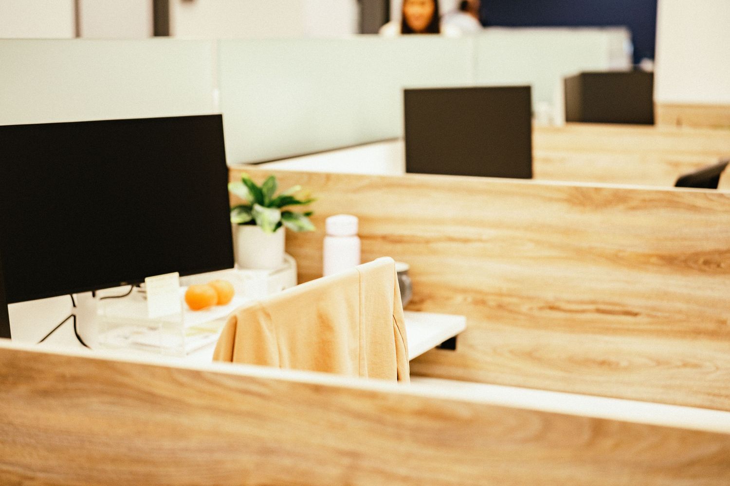 Close-up view of wooden table surfaces in a modern interior setting with natural lighting.