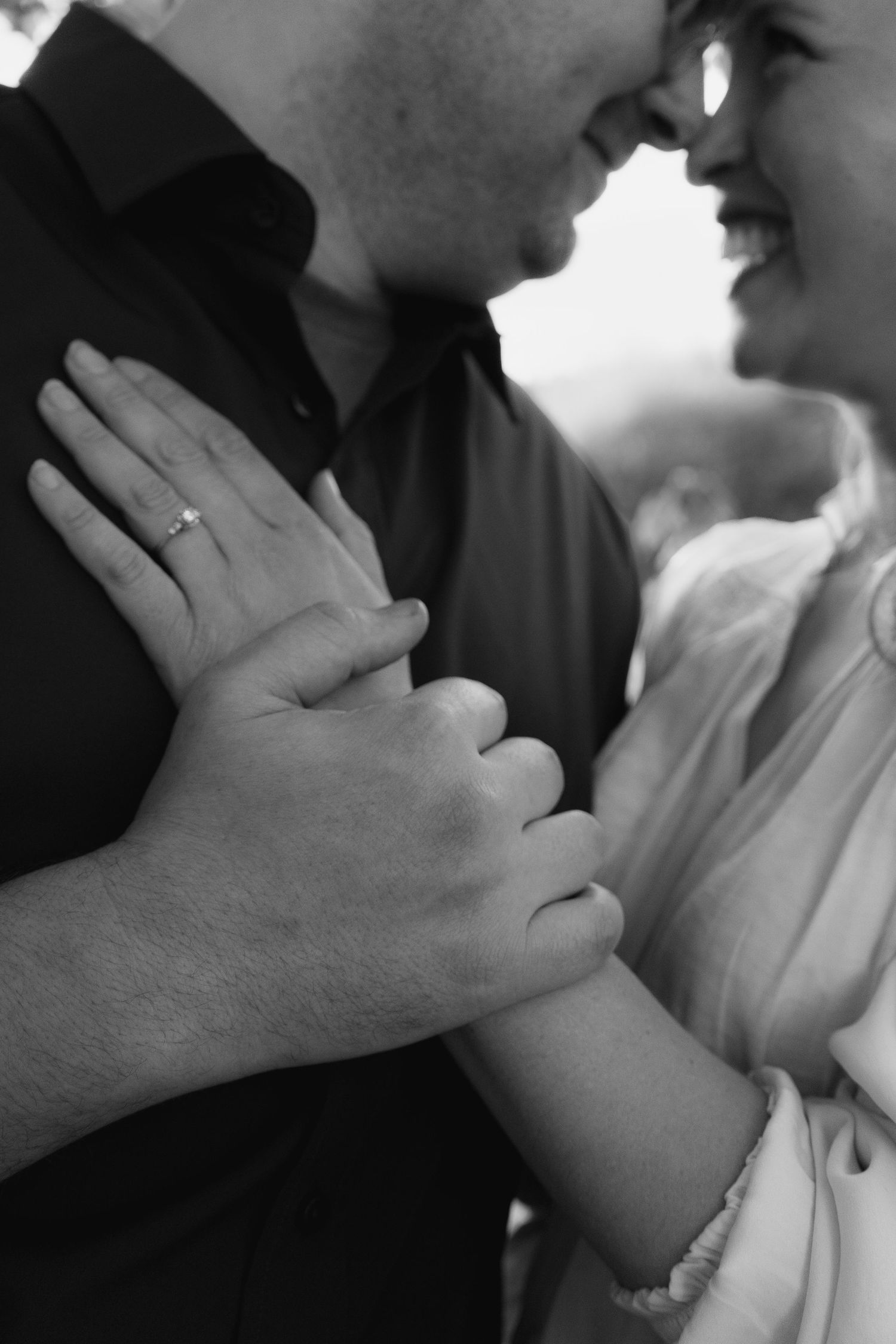 A series of black and white close-up photos showing hands tenderly touching and caressing in an intimate moment.