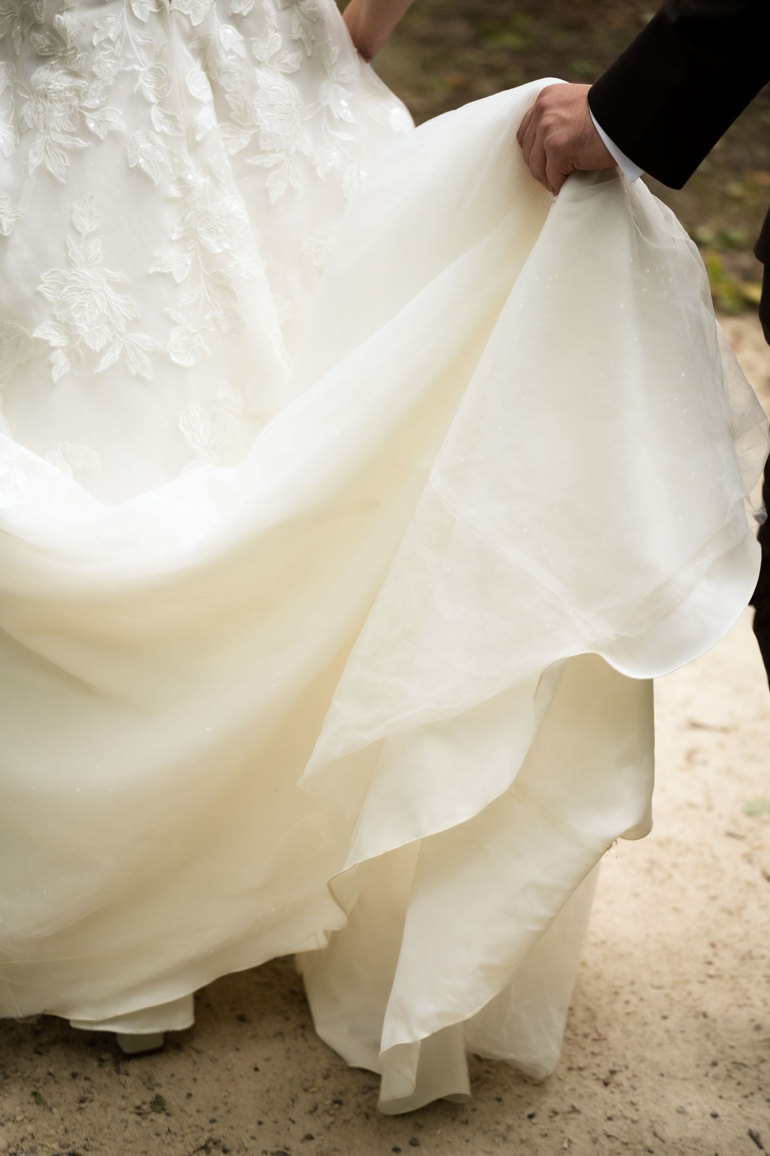 bride's dress carried by groom