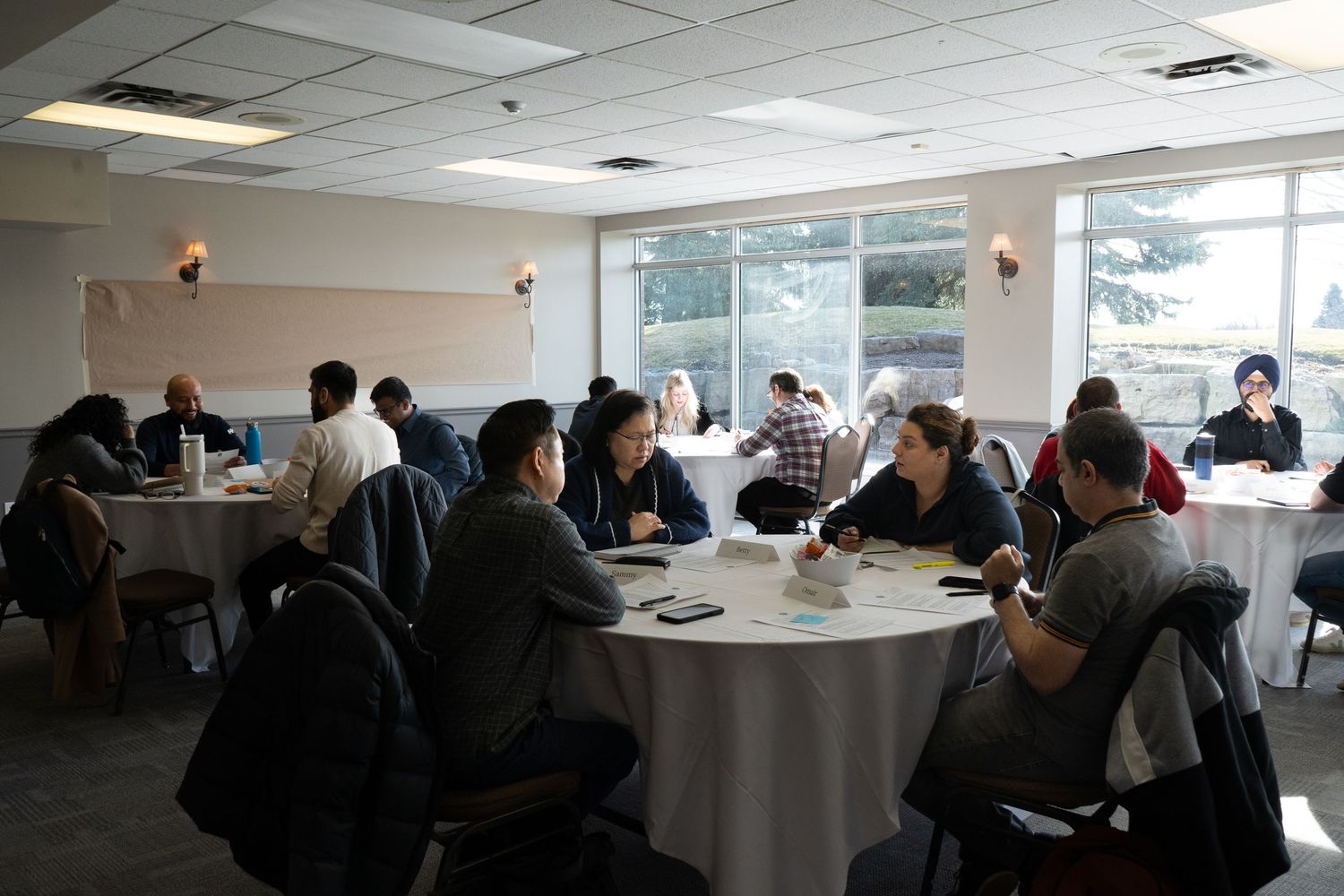 People talking at tables