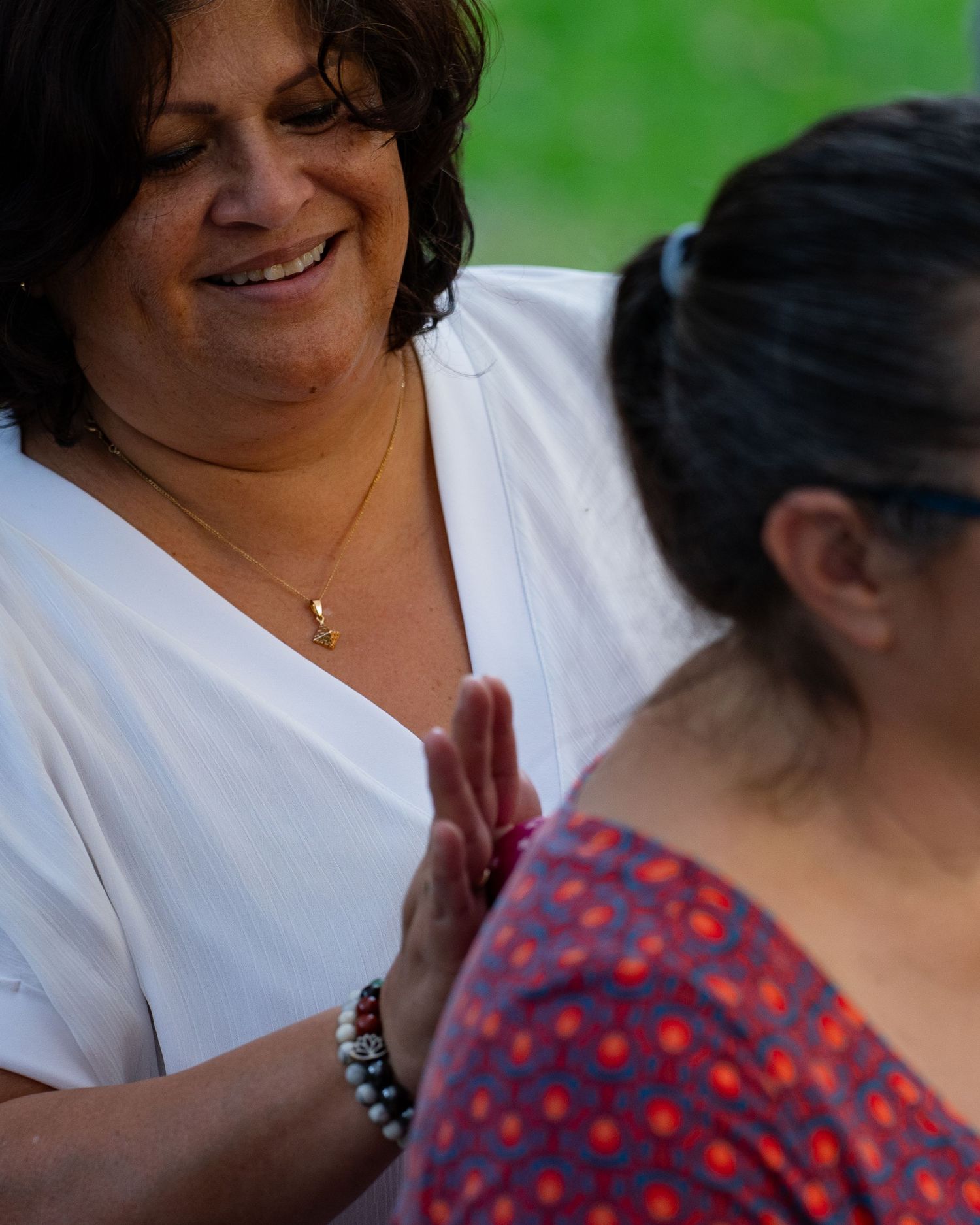 women smiles while working with another