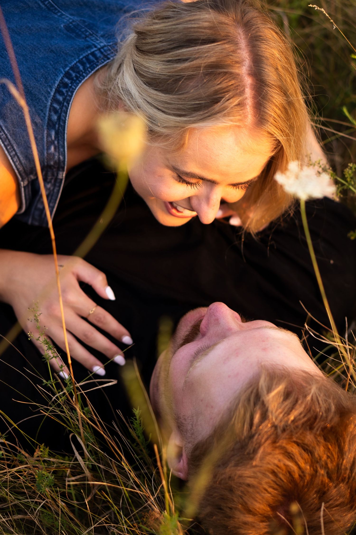 Man and women lie together in flowers